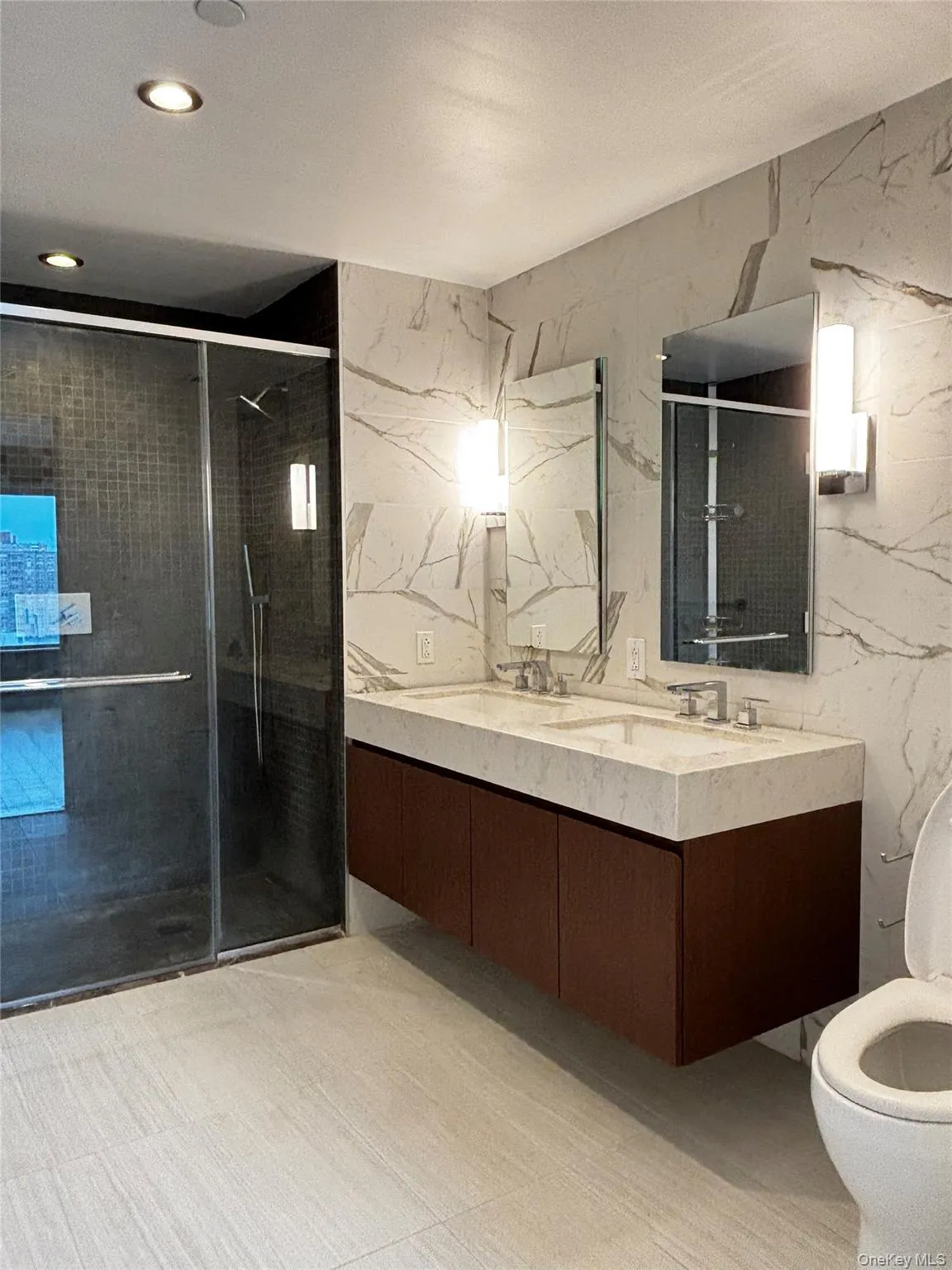 Full bathroom with a stall shower, double vanity, tile walls, and stone wall Full bathroom with a stall shower, double vanity, tile walls, and stone wall
