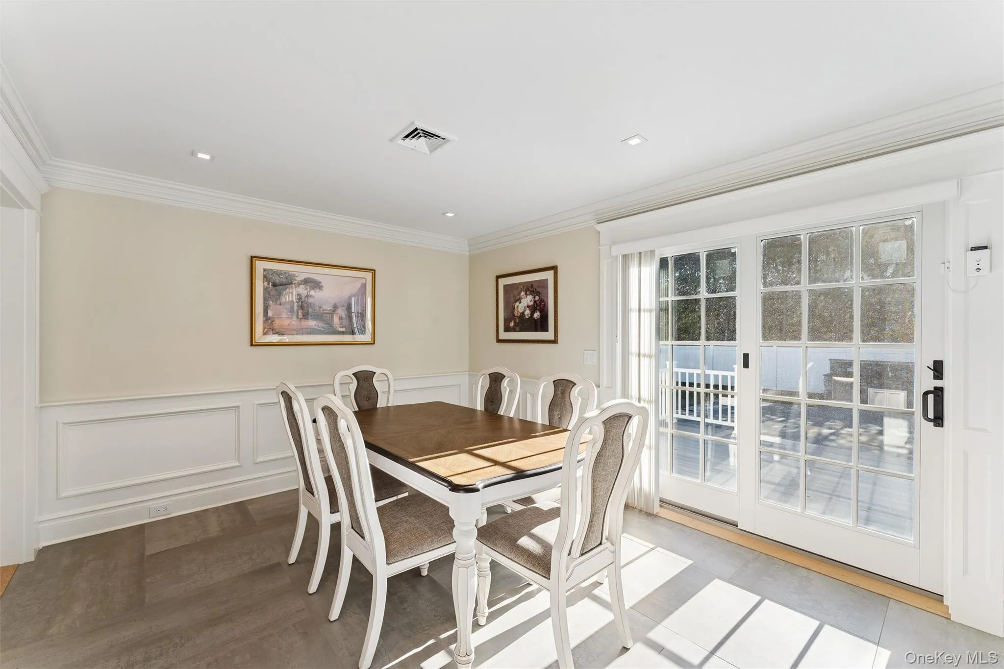 Dining space featuring wainscoted walls and crown molding. Dining space featuring wainscoted walls and crown molding.