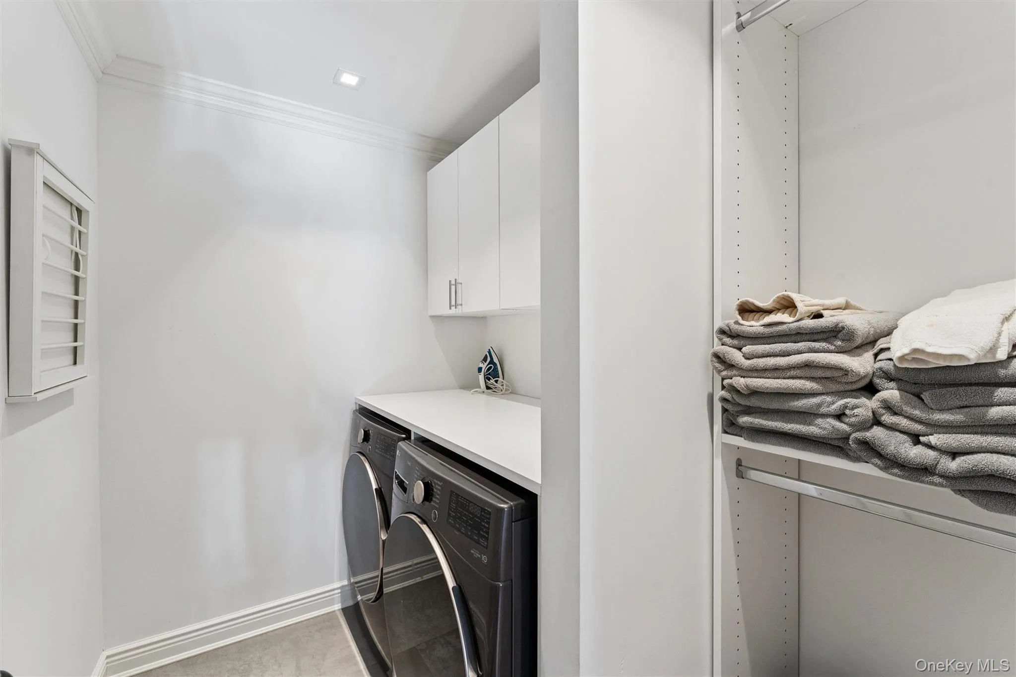 Laundry room featuring cabinet space, and independent washer and dryer. Laundry room featuring cabinet space, and independent washer and dryer.