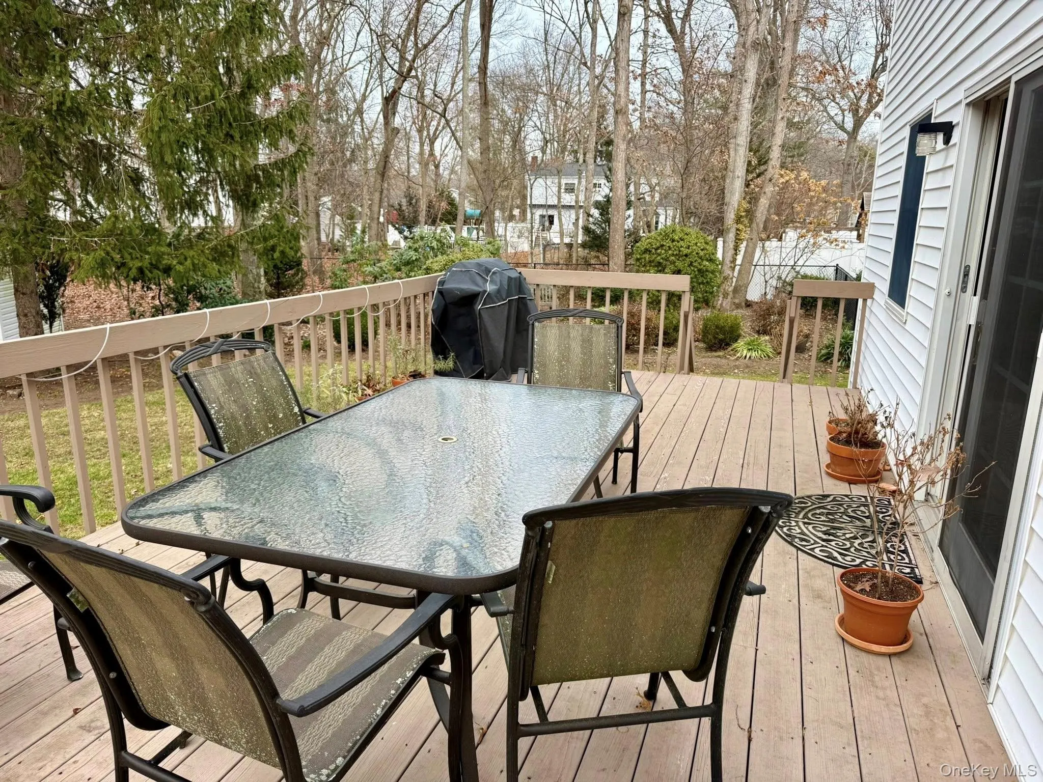 Wooden terrace with outdoor dining space and grilling area Wooden terrace with outdoor dining space and grilling area