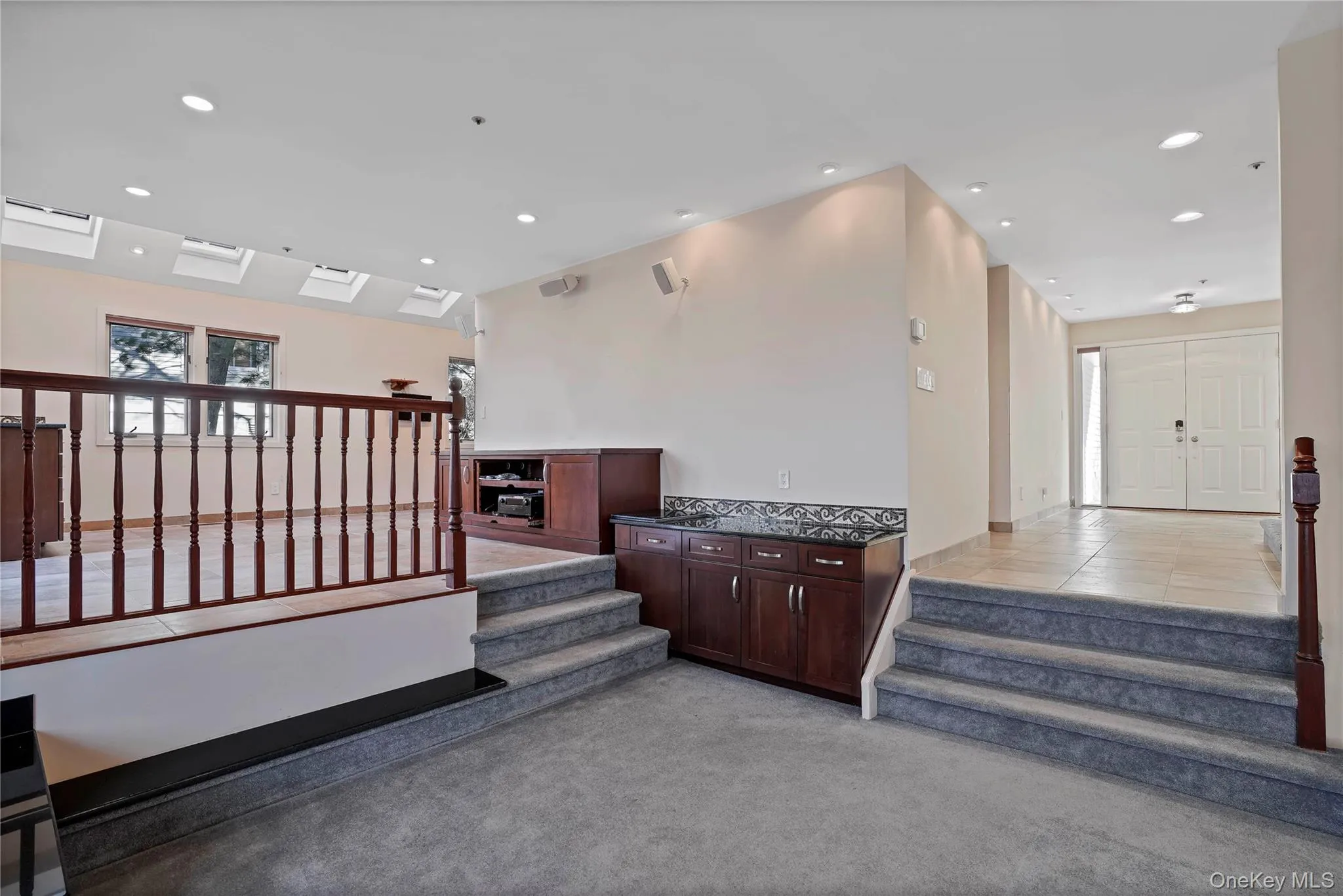Stairway featuring recessed lighting, carpet floors, and tile patterned flooring Stairway featuring recessed lighting, carpet floors, and tile patterned flooring