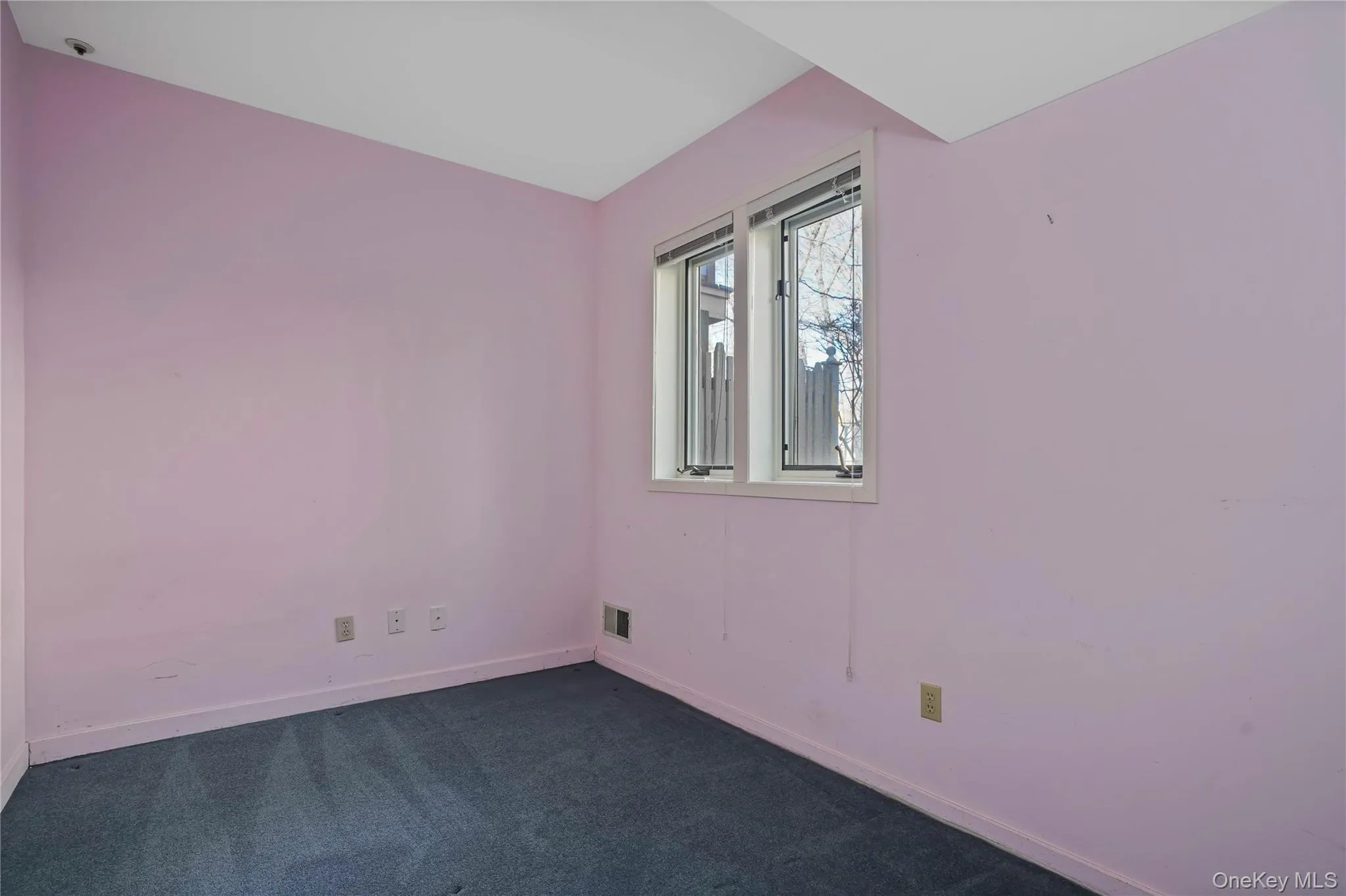 Spare room with baseboards and dark colored carpet Spare room with baseboards and dark colored carpet