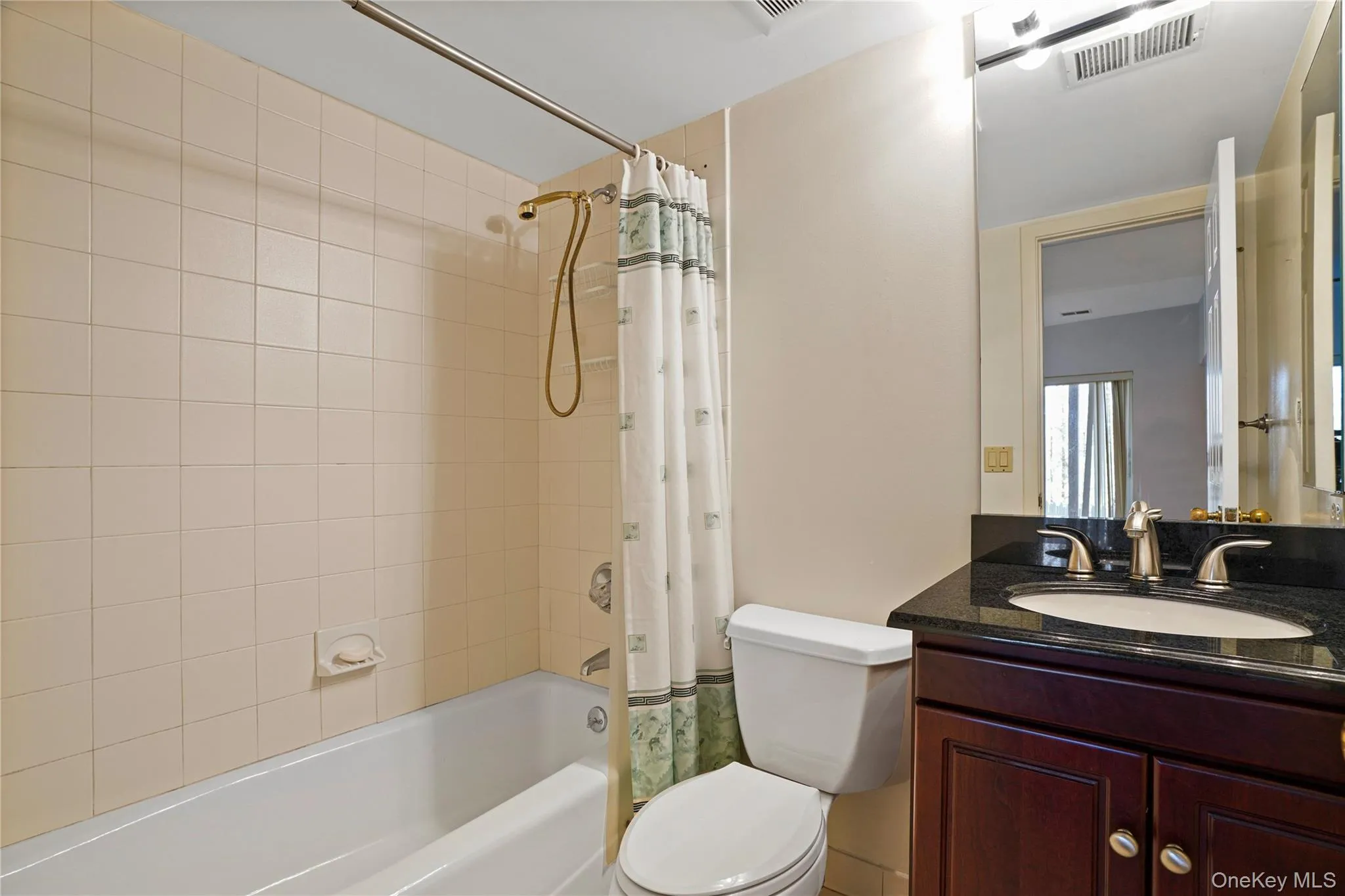 Full bath featuring vanity and shower / tub combo Full bath featuring vanity and shower / tub combo