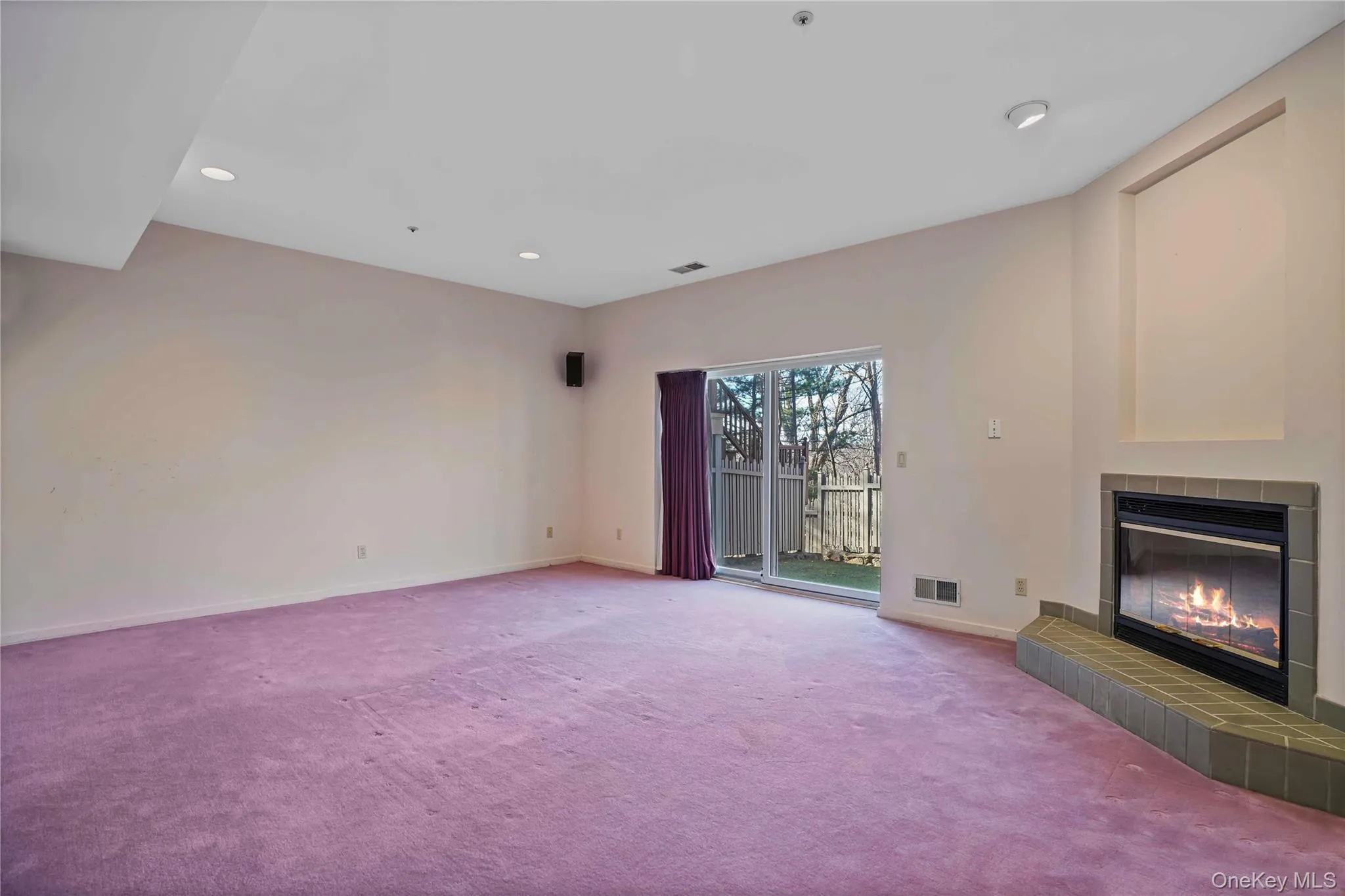 Unfurnished living room featuring carpet floors, a fireplace, and recessed lighting Unfurnished living room featuring carpet floors, a fireplace, and recessed lighting