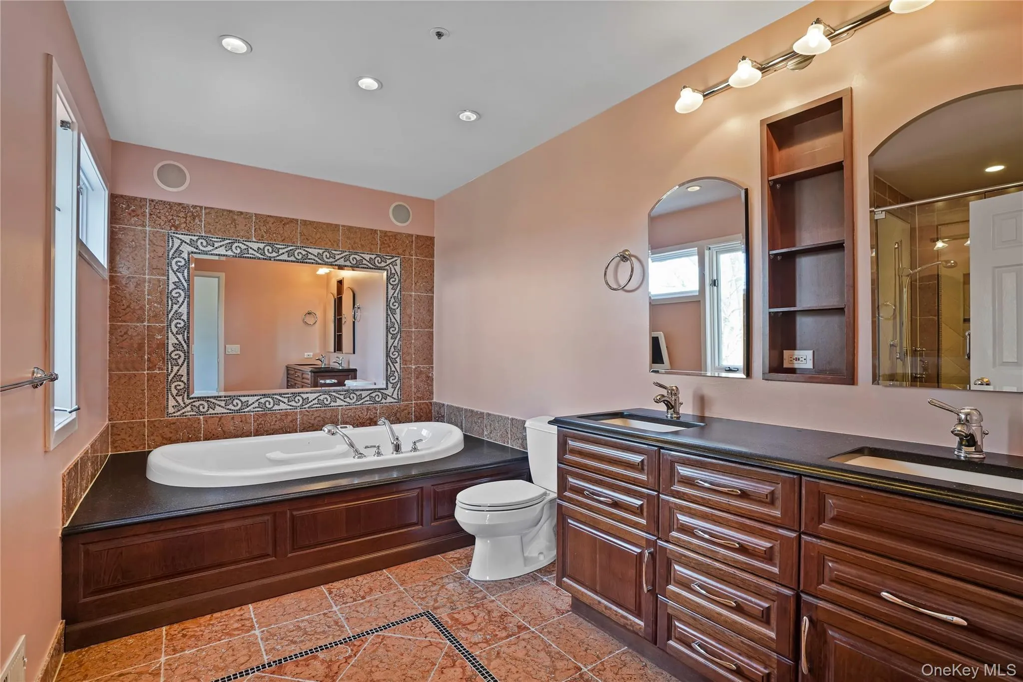 Full bath featuring double vanity, a garden tub, a shower stall, recessed lighting, and light tile patterned floors Full bath featuring double vanity, a garden tub, a shower stall, recessed lighting, and light tile patterned floors
