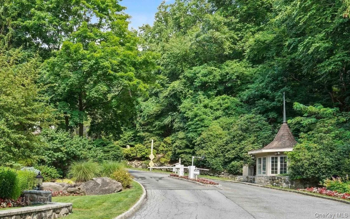 View of asphalt street with curbs and a gated entry View of asphalt street with curbs and a gated entry