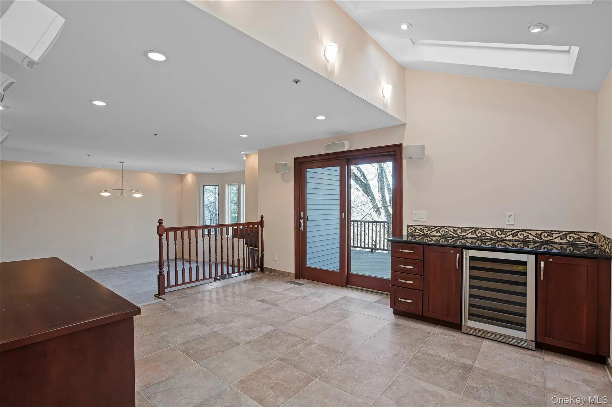 Bar featuring wine cooler, recessed lighting, dark stone counters, hanging light fixtures, and dark brown cabinetry Bar featuring wine cooler, recessed lighting, dark stone counters, hanging light fixtures, and dark brown cabinetry