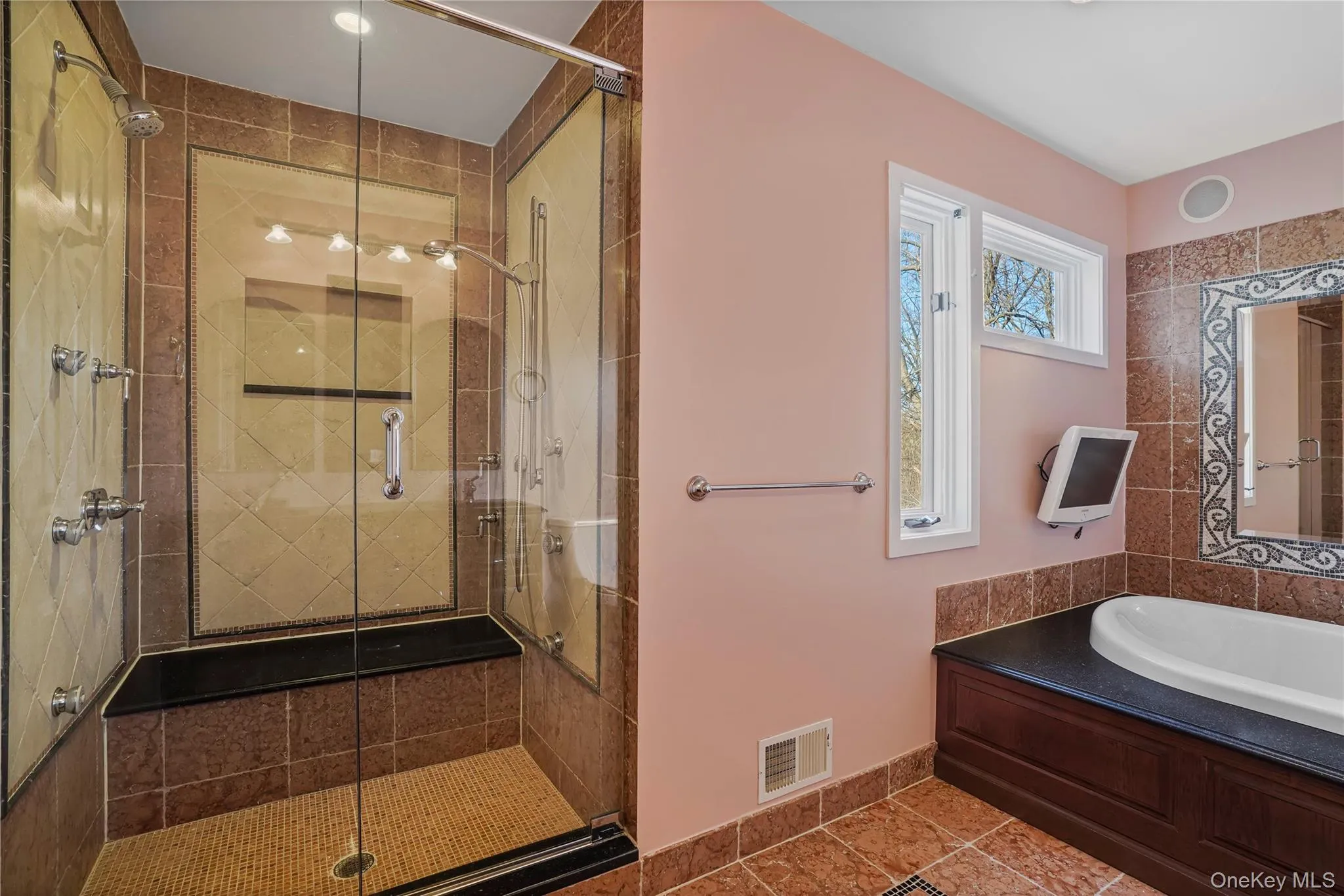 Bathroom with a stall shower, tile patterned floors, and a garden tub Bathroom with a stall shower, tile patterned floors, and a garden tub