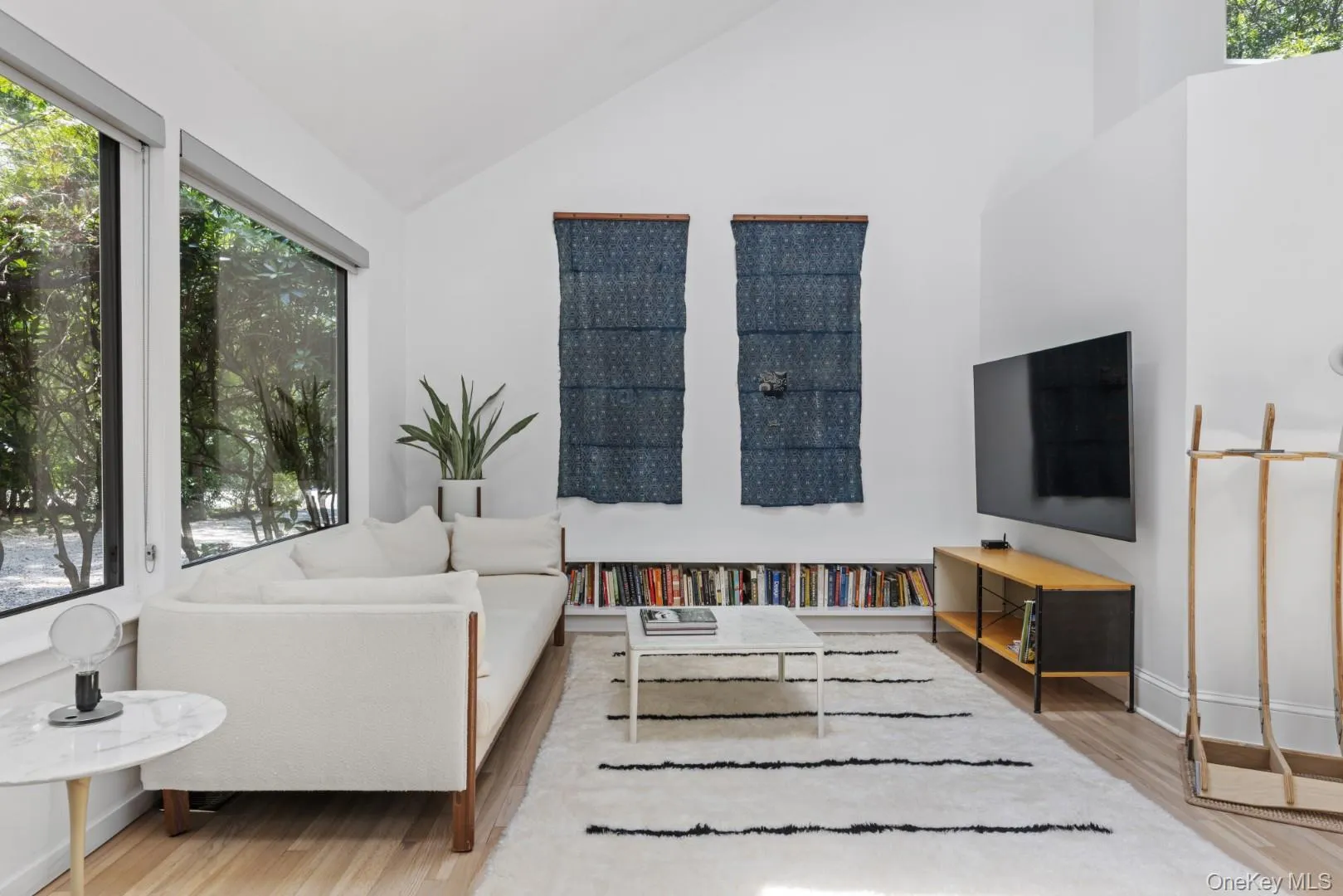 Living room with vaulted ceiling and light wood-style floors Living room with vaulted ceiling and light wood-style floors
