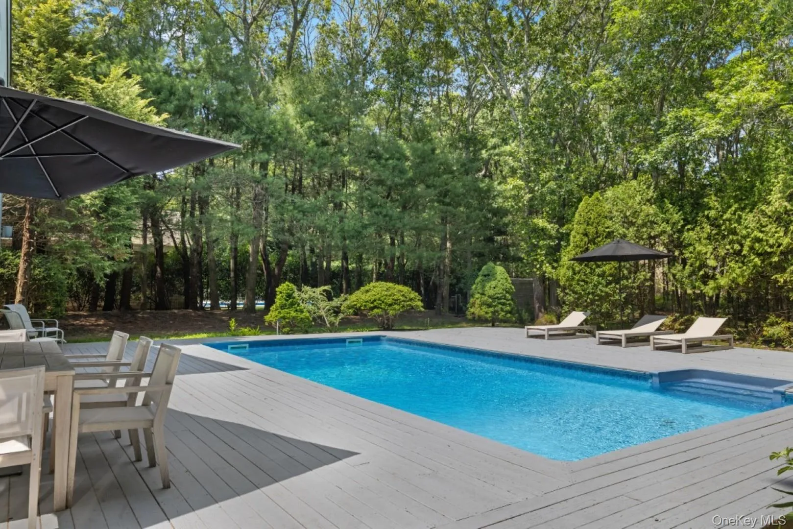 Outdoor pool featuring outdoor dining area and a deck Outdoor pool featuring outdoor dining area and a deck