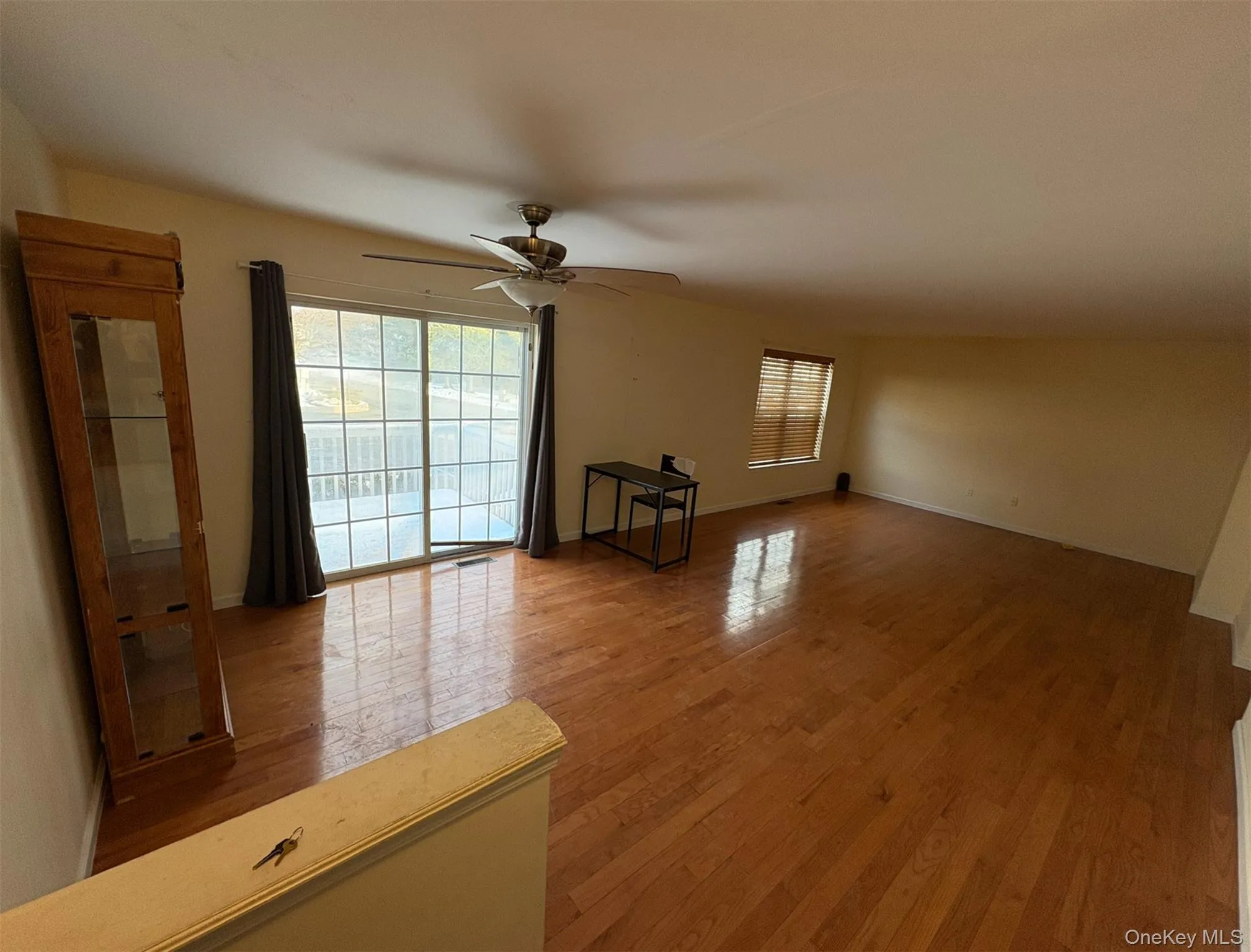 Empty room with light wood-type flooring and a ceiling fan Empty room with light wood-type flooring and a ceiling fan