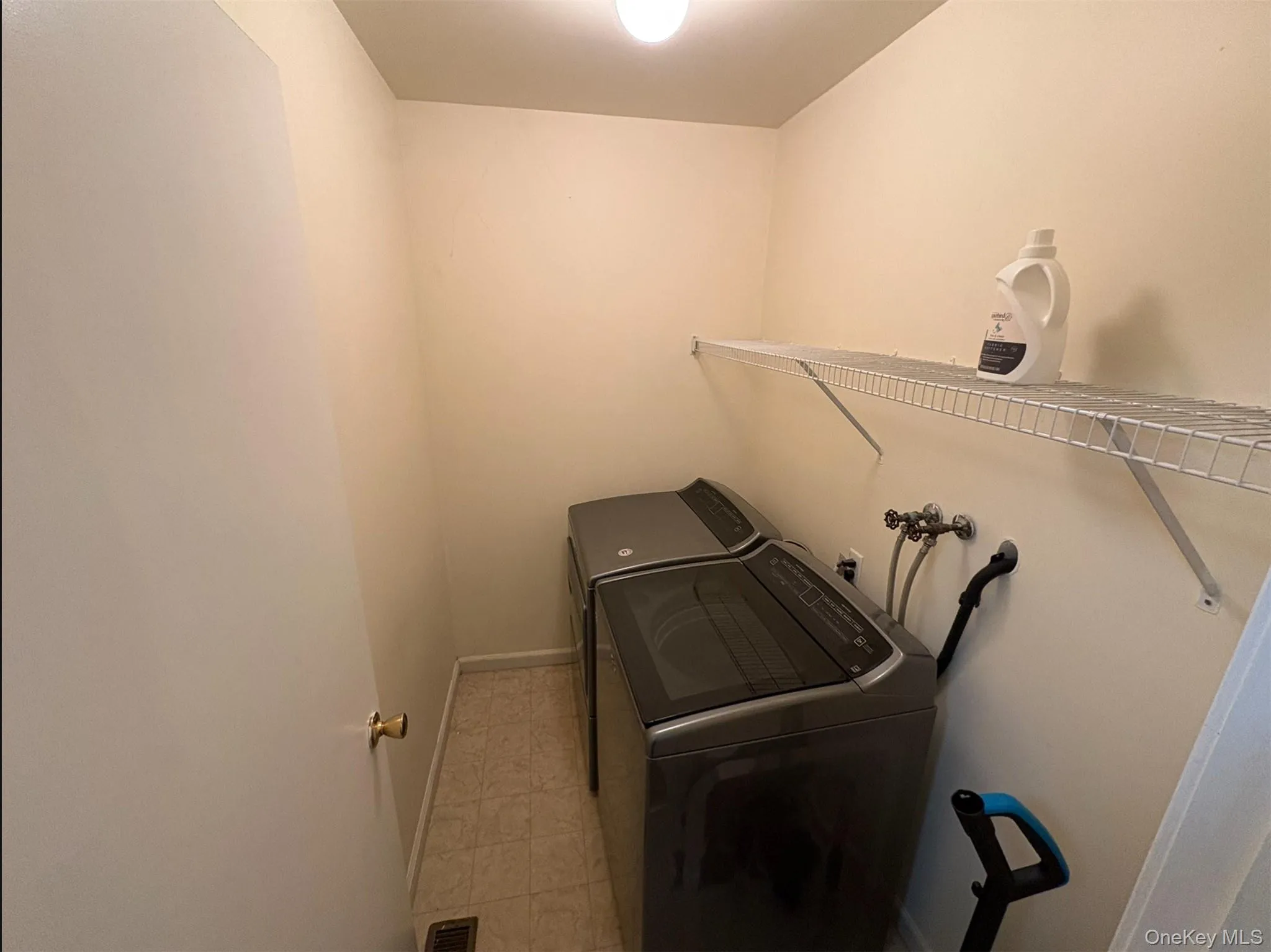 Washroom featuring baseboards and separate washer and dryer Washroom featuring baseboards and separate washer and dryer