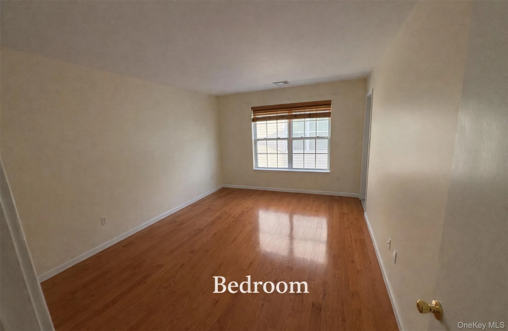 Unfurnished room featuring light wood finished floors and baseboards Unfurnished room featuring light wood finished floors and baseboards