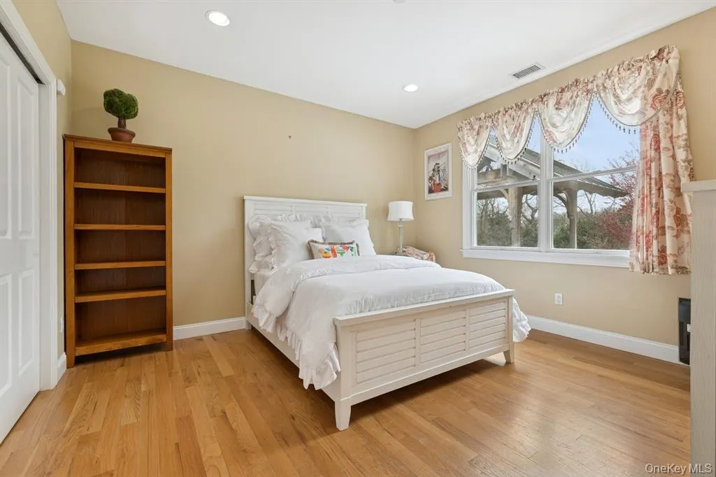 Bedroom featuring light wood finished floors, recessed lighting, and a closet Bedroom featuring light wood finished floors, recessed lighting, and a closet
