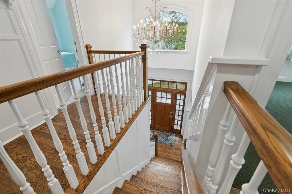 Entryway with a chandelier, a high ceiling, and dark wood finished floors Entryway with a chandelier, a high ceiling, and dark wood finished floors