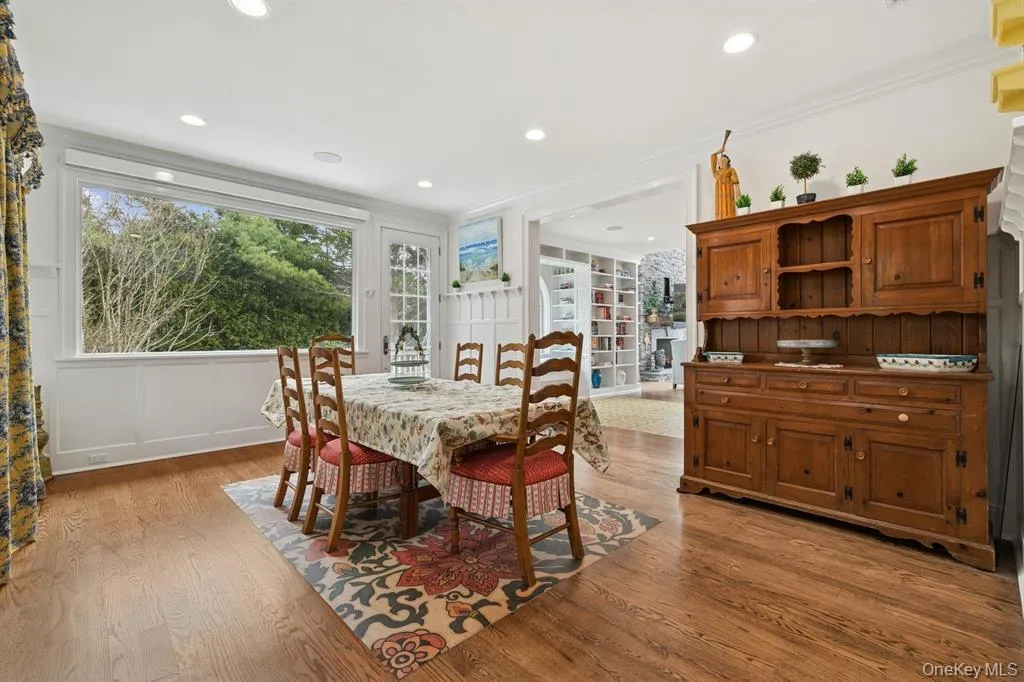 Dining space with light wood finished floors, a decorative wall, healthy amount of natural light, ornamental molding, and recessed lighting Dining space with light wood finished floors, a decorative wall, healthy amount of natural light, ornamental molding, and recessed lighting