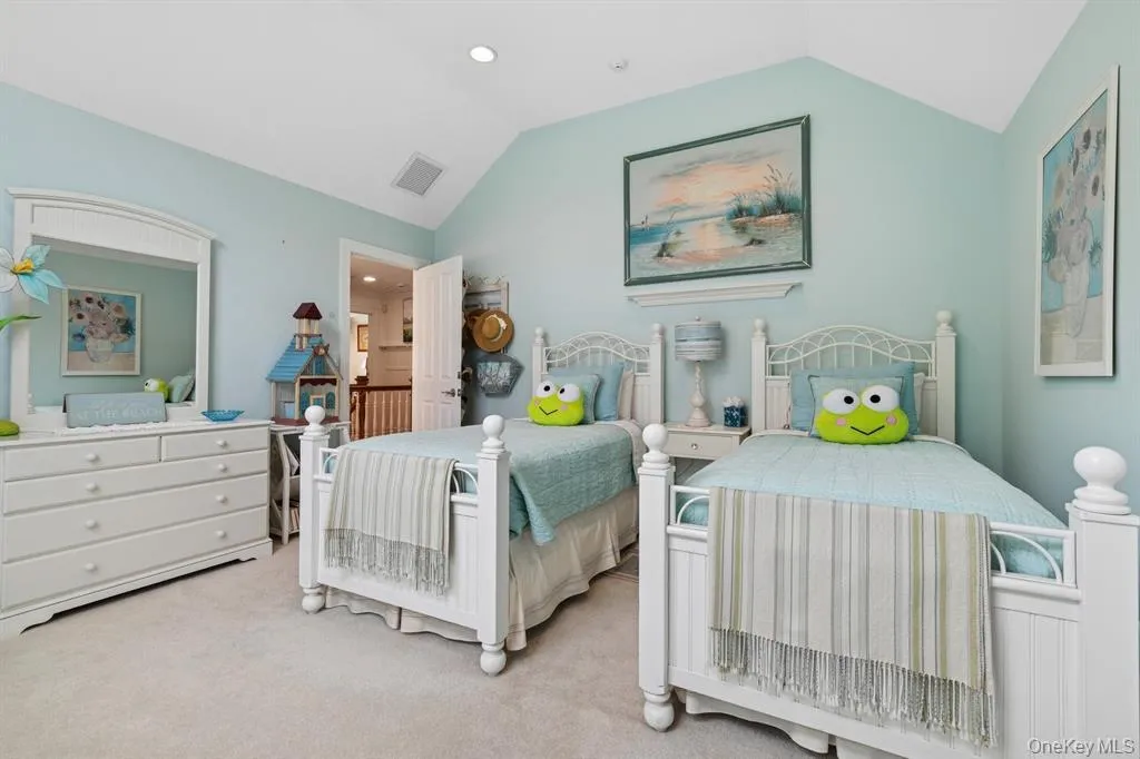 Carpeted bedroom with lofted ceiling and recessed lighting Carpeted bedroom with lofted ceiling and recessed lighting