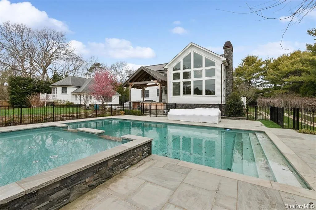 View of pool featuring a pool with connected hot tub, a patio area, a fenced backyard, and area for grilling View of pool featuring a pool with connected hot tub, a patio area, a fenced backyard, and area for grilling