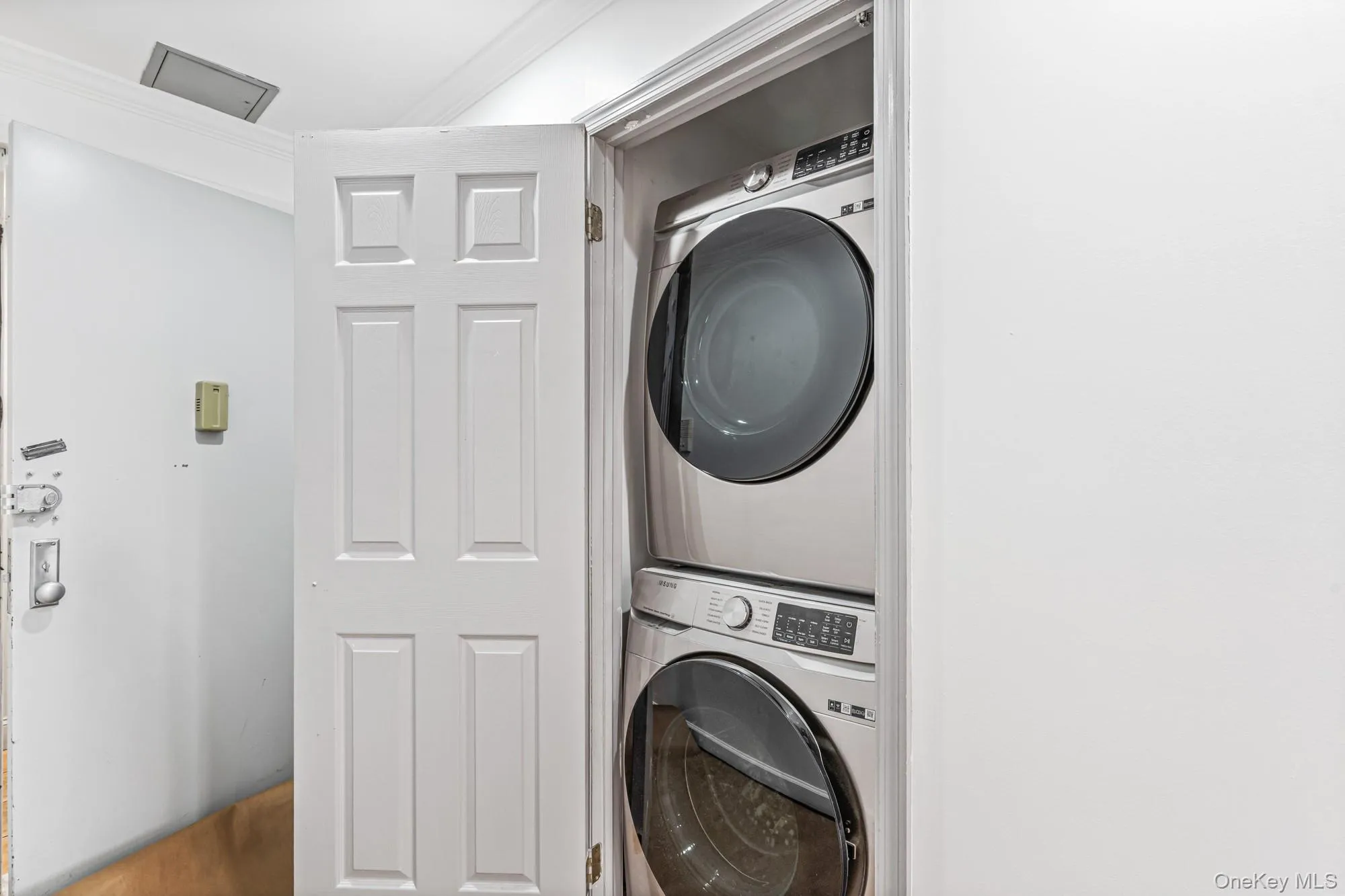 Laundry room with stacked washing machine and dryer Laundry room with stacked washing machine and dryer