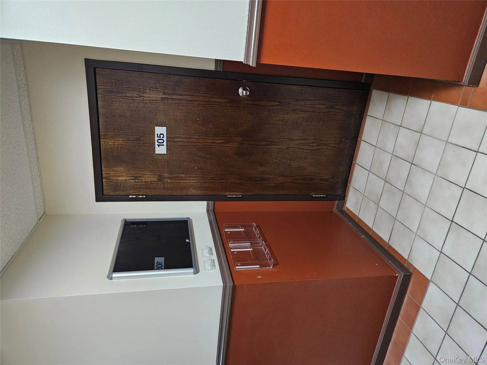 Doorway with tile patterned floors and a textured ceiling Doorway with tile patterned floors and a textured ceiling