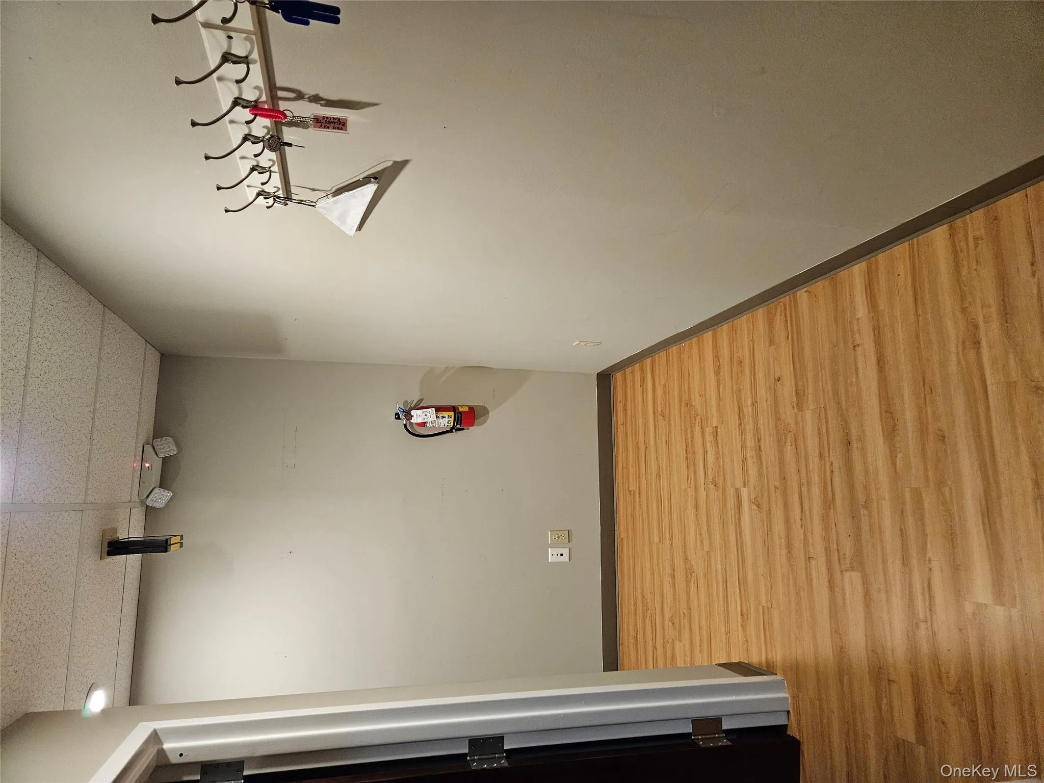 Hallway with a paneled ceiling and light wood-style floors Hallway with a paneled ceiling and light wood-style floors