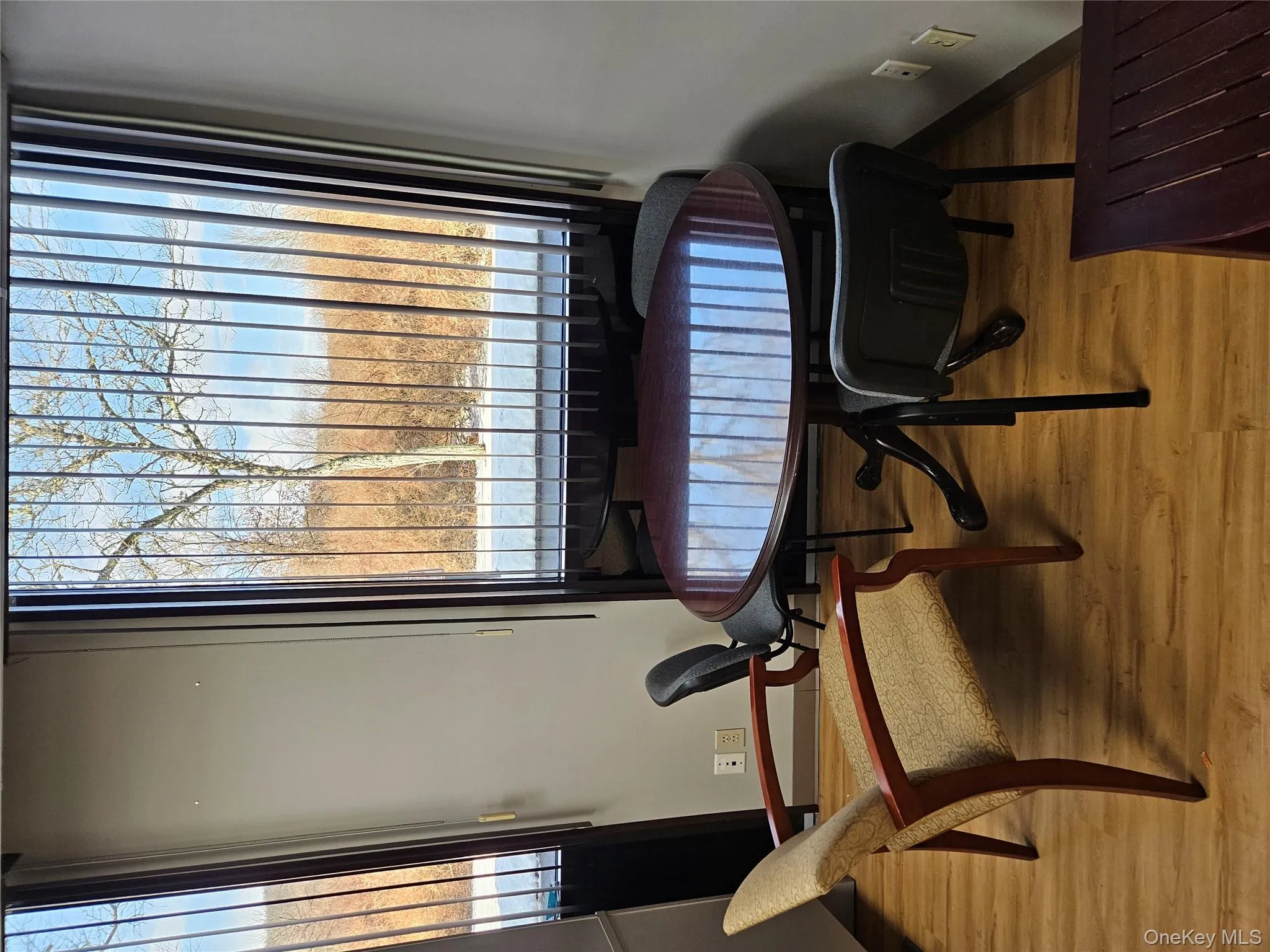 Dining area featuring light wood-style flooring and a water view Dining area featuring light wood-style flooring and a water view