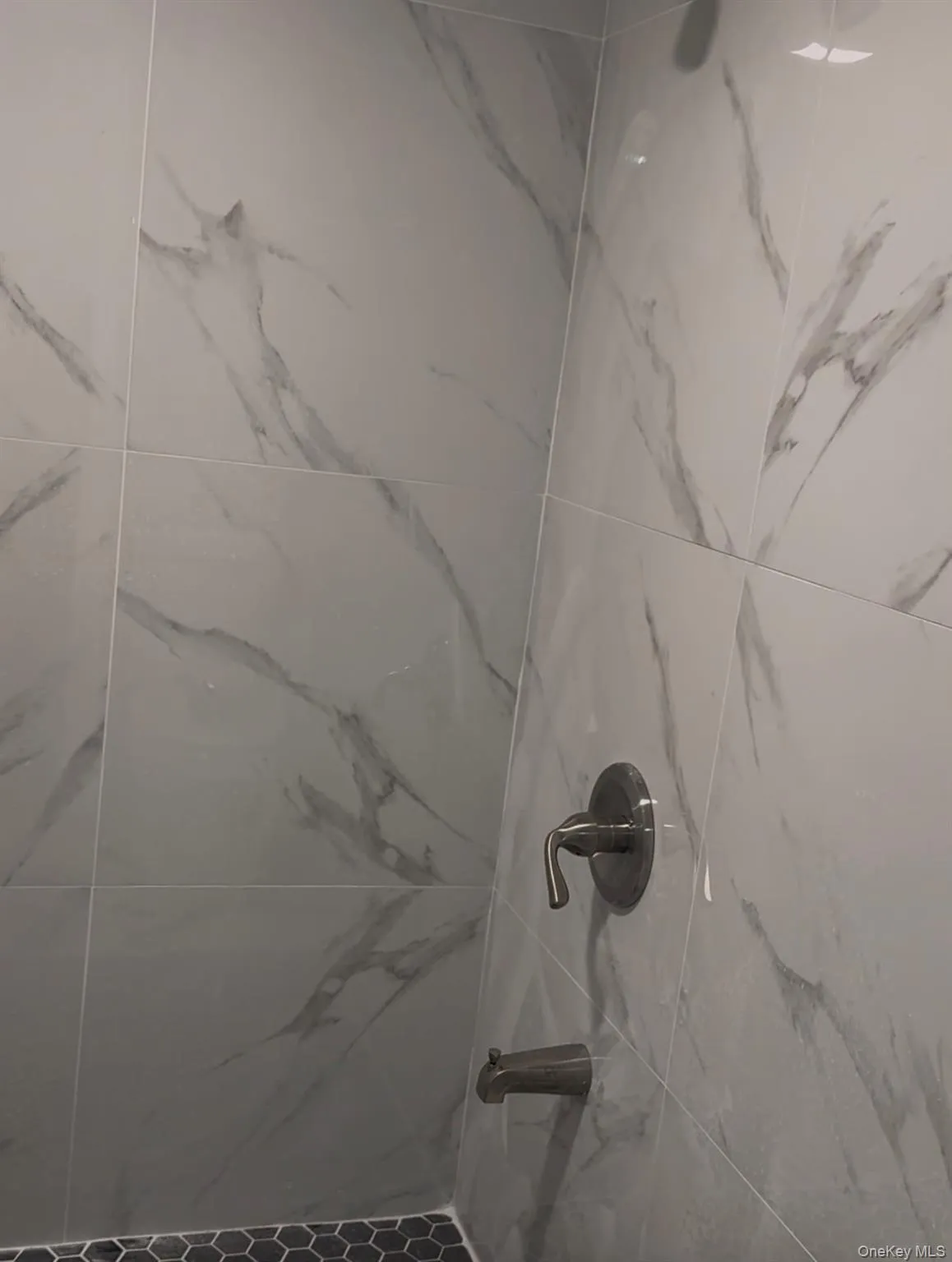 Bathroom view of a marble finish shower Bathroom view of a marble finish shower