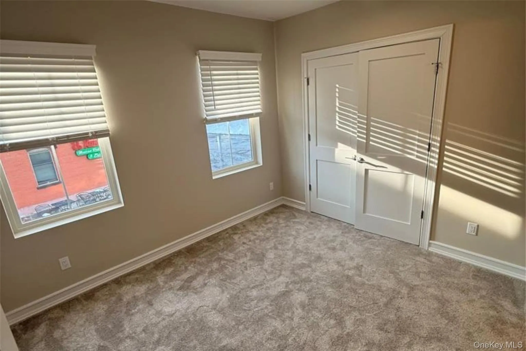Unfurnished bedroom with carpet flooring and a closet Unfurnished bedroom with carpet flooring and a closet
