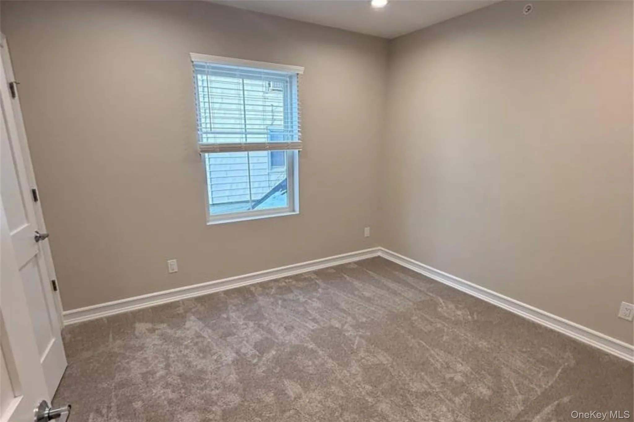 Carpeted spare room featuring baseboards and recessed lighting Carpeted spare room featuring baseboards and recessed lighting