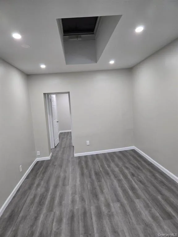 Spare room with dark wood-style floors and recessed lighting Spare room with dark wood-style floors and recessed lighting