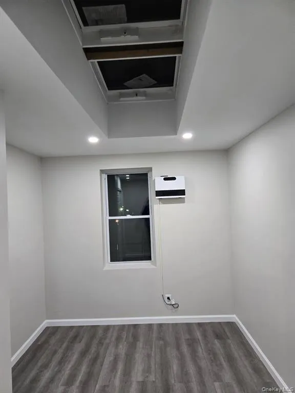 Empty room with recessed lighting and dark wood-type flooring Empty room with recessed lighting and dark wood-type flooring