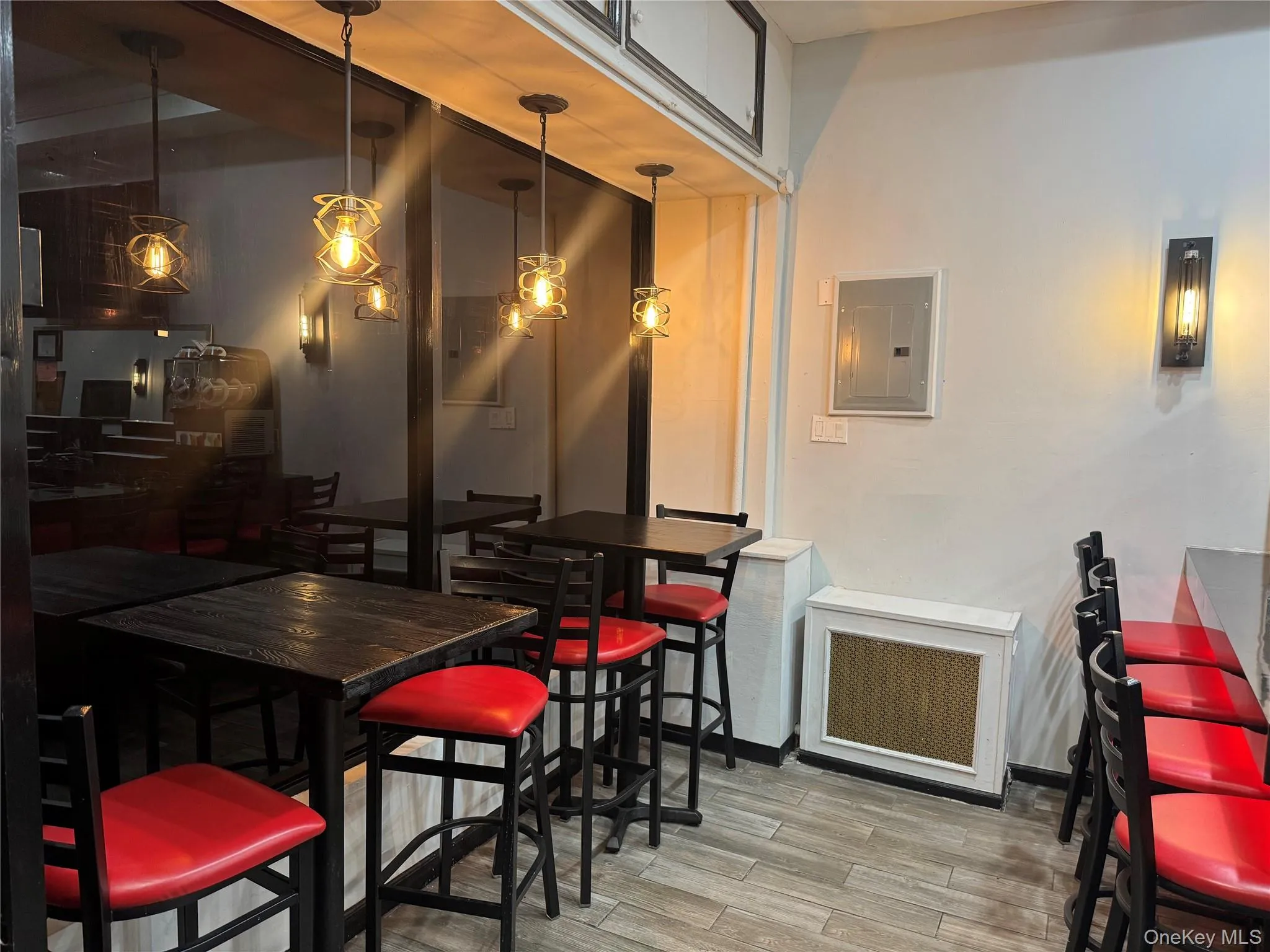 Dining area with electric panel, radiator heating unit, and wood finished floors Dining area with electric panel, radiator heating unit, and wood finished floors