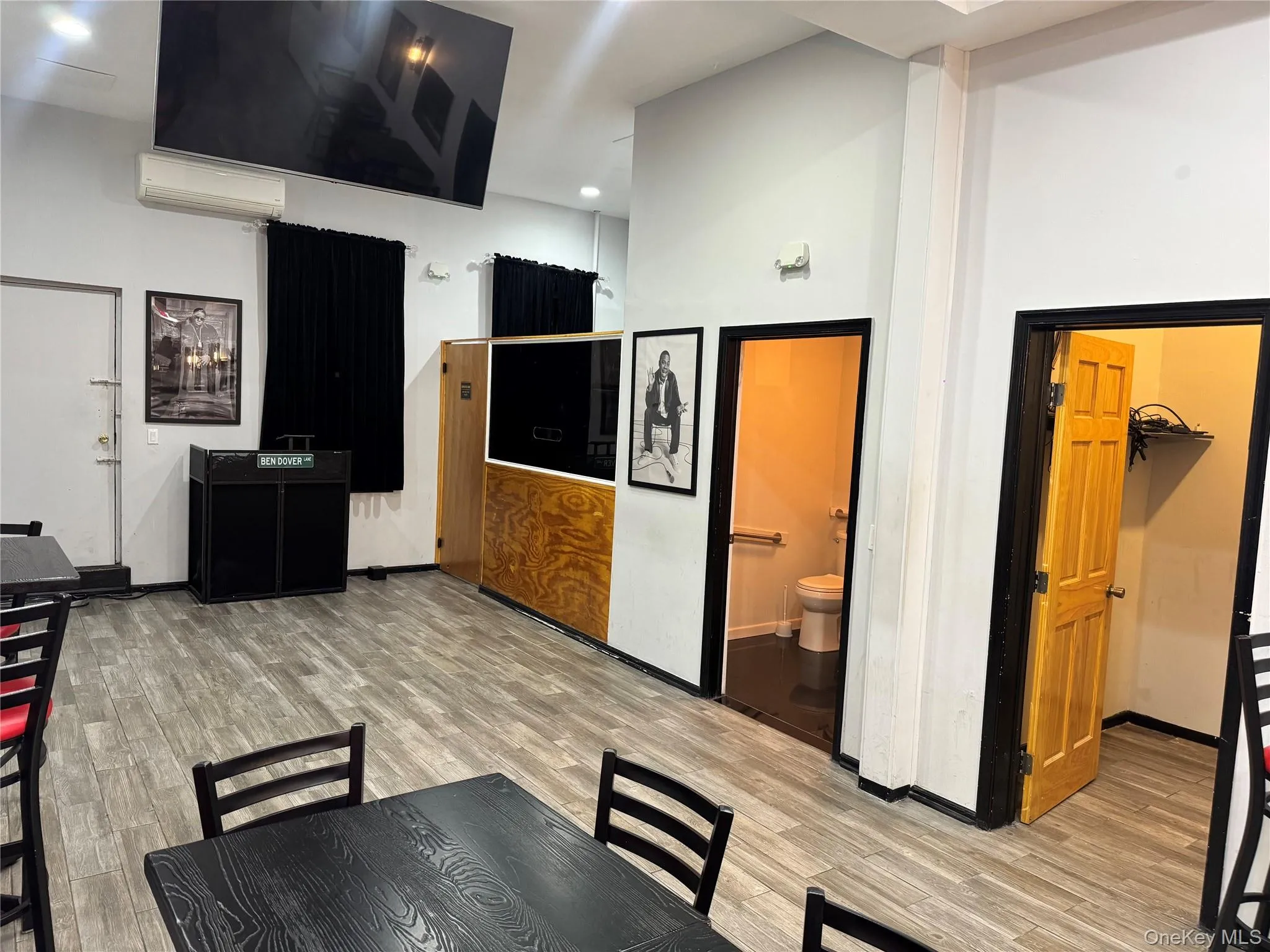 Dining space with light wood-style flooring, recessed lighting, and an AC wall unit Dining space with light wood-style flooring, recessed lighting, and an AC wall unit