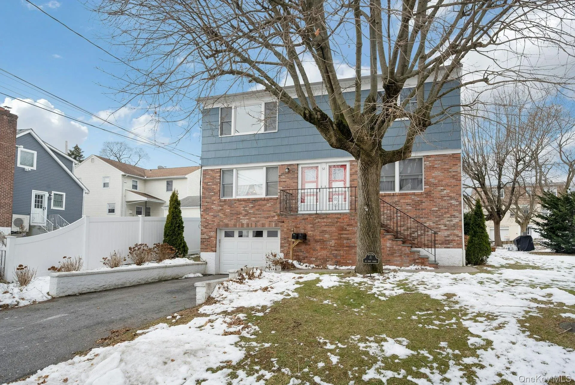 View of front facade featuring brick siding and an attached garage View of front facade featuring brick siding and an attached garage