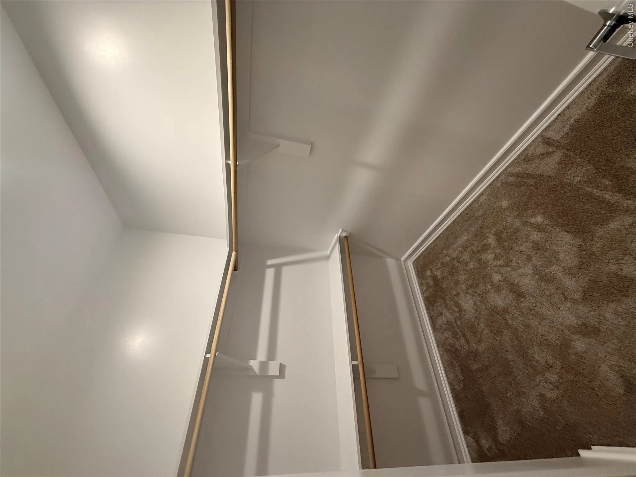 Spacious closet with dark colored carpet Spacious closet with dark colored carpet