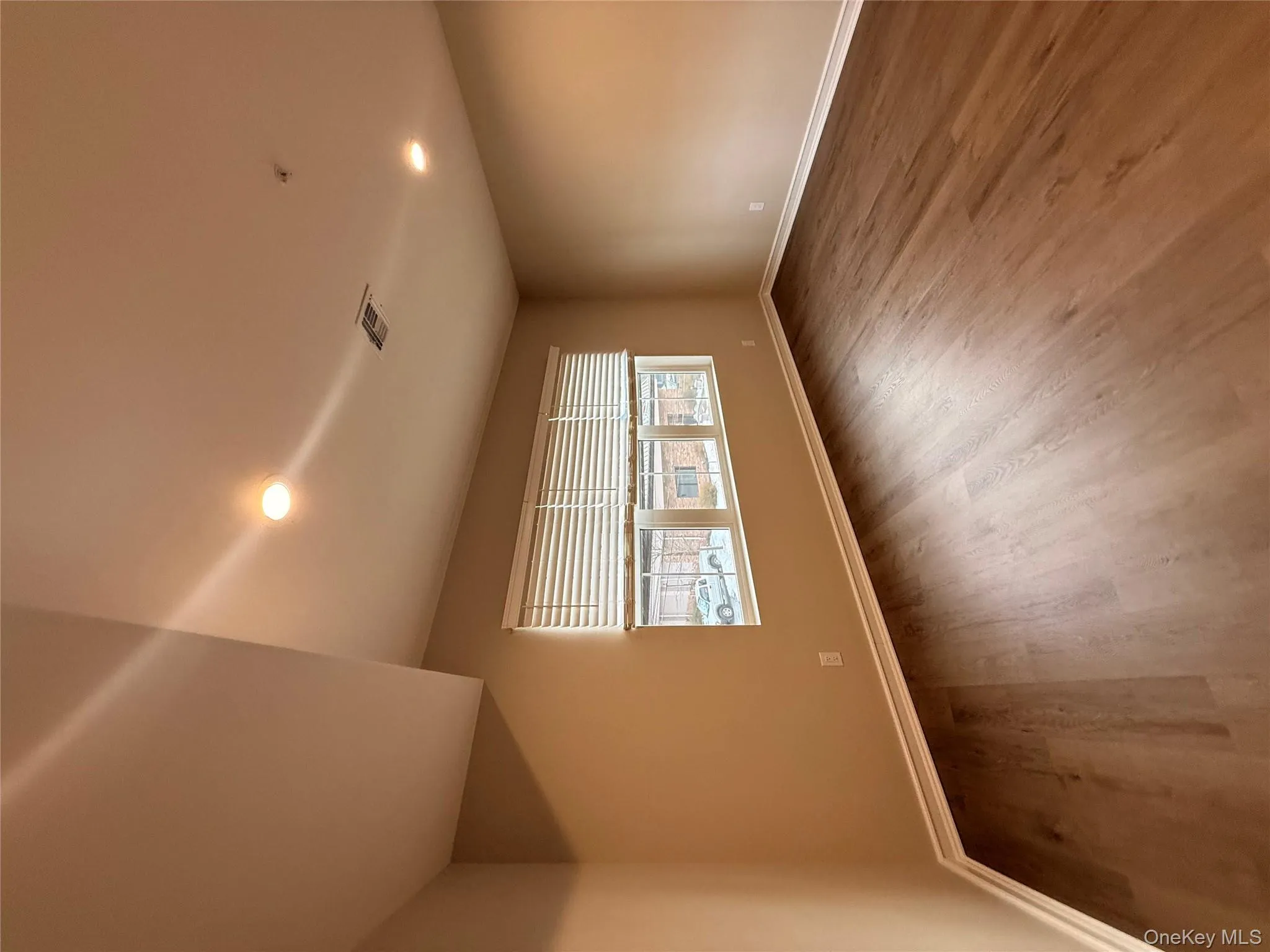 Spare room featuring recessed lighting and dark wood-type flooring Spare room featuring recessed lighting and dark wood-type flooring