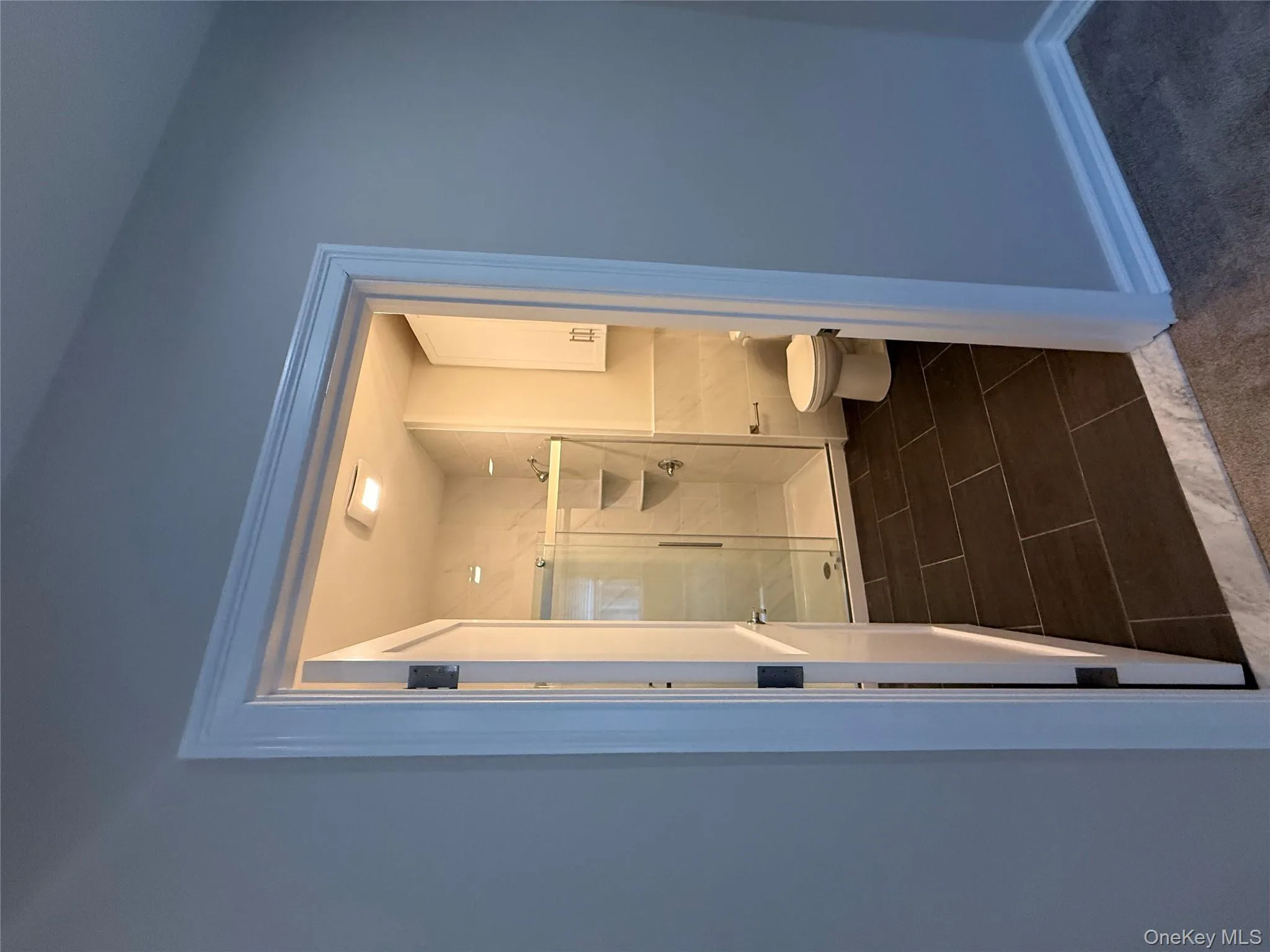 Full bath with a stall shower and dark tile patterned floors Full bath with a stall shower and dark tile patterned floors