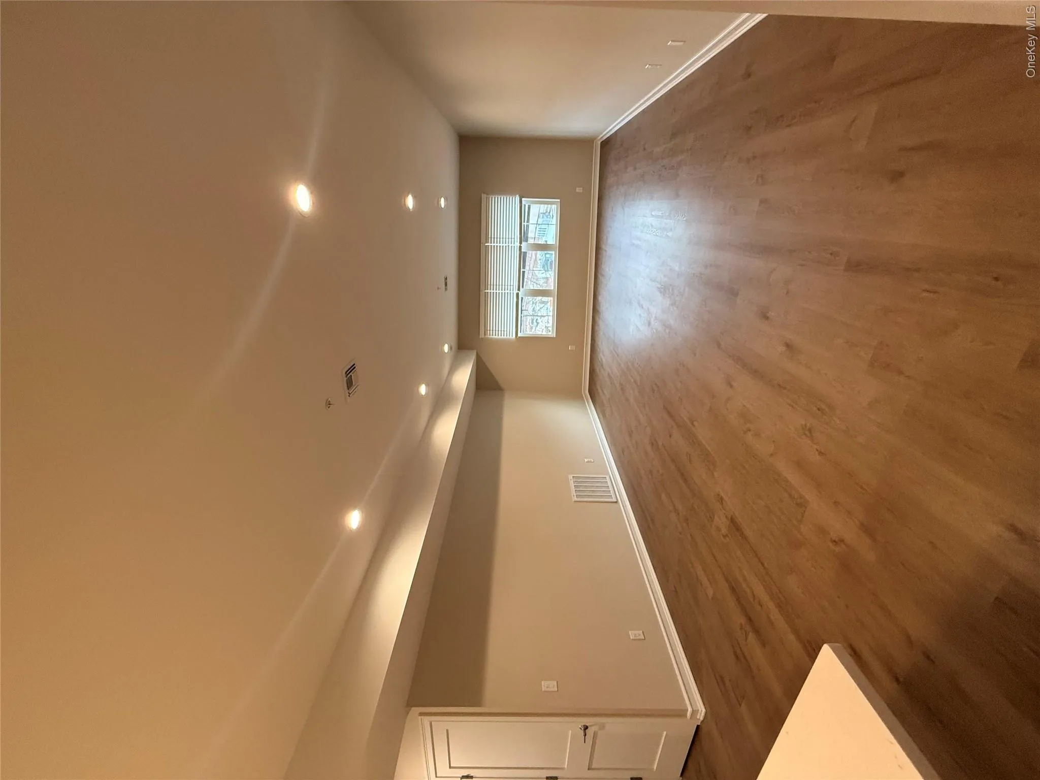 Spare room featuring recessed lighting and dark wood-style flooring Spare room featuring recessed lighting and dark wood-style flooring