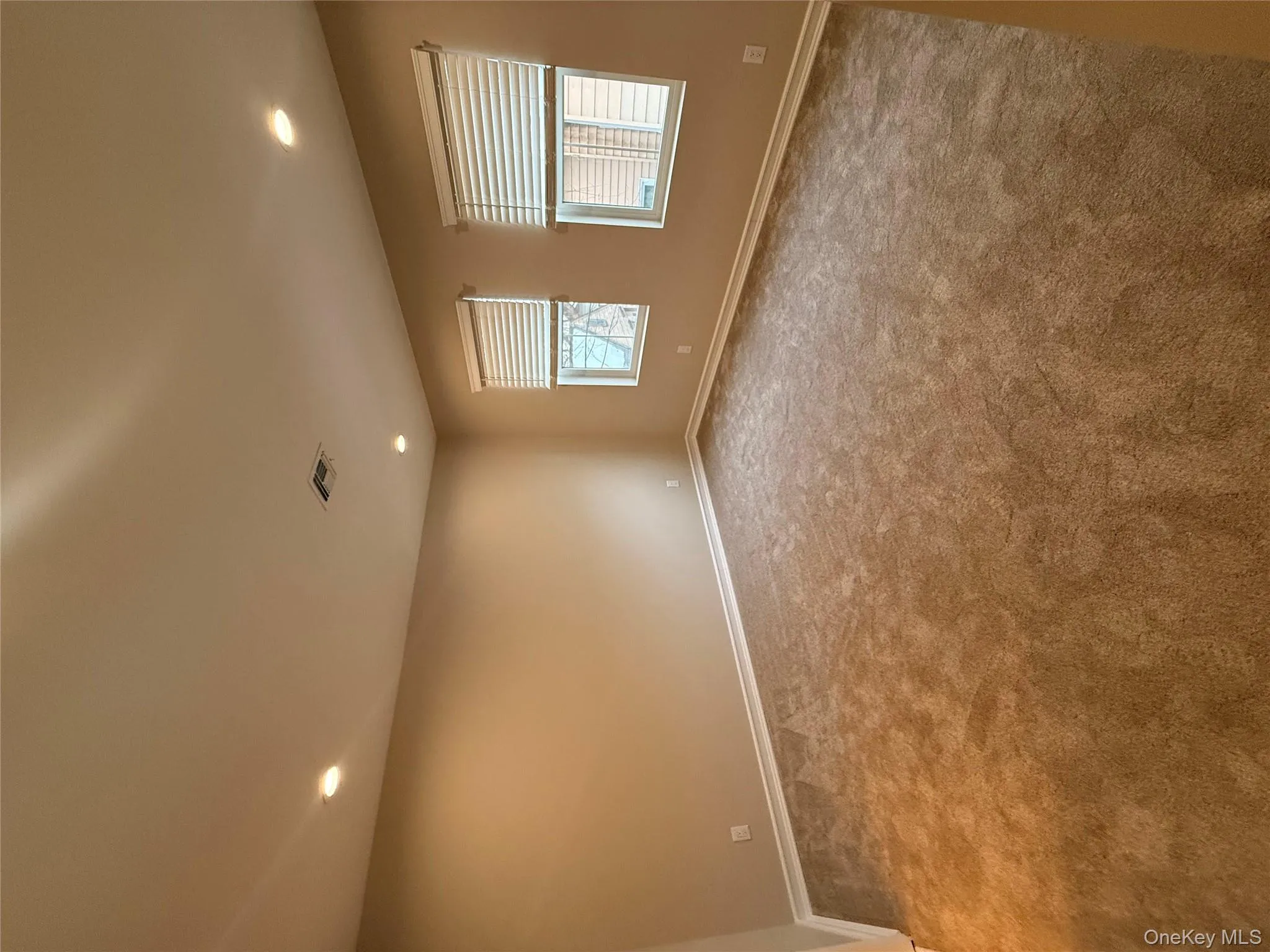 Unfurnished room with recessed lighting and light colored carpet Unfurnished room with recessed lighting and light colored carpet