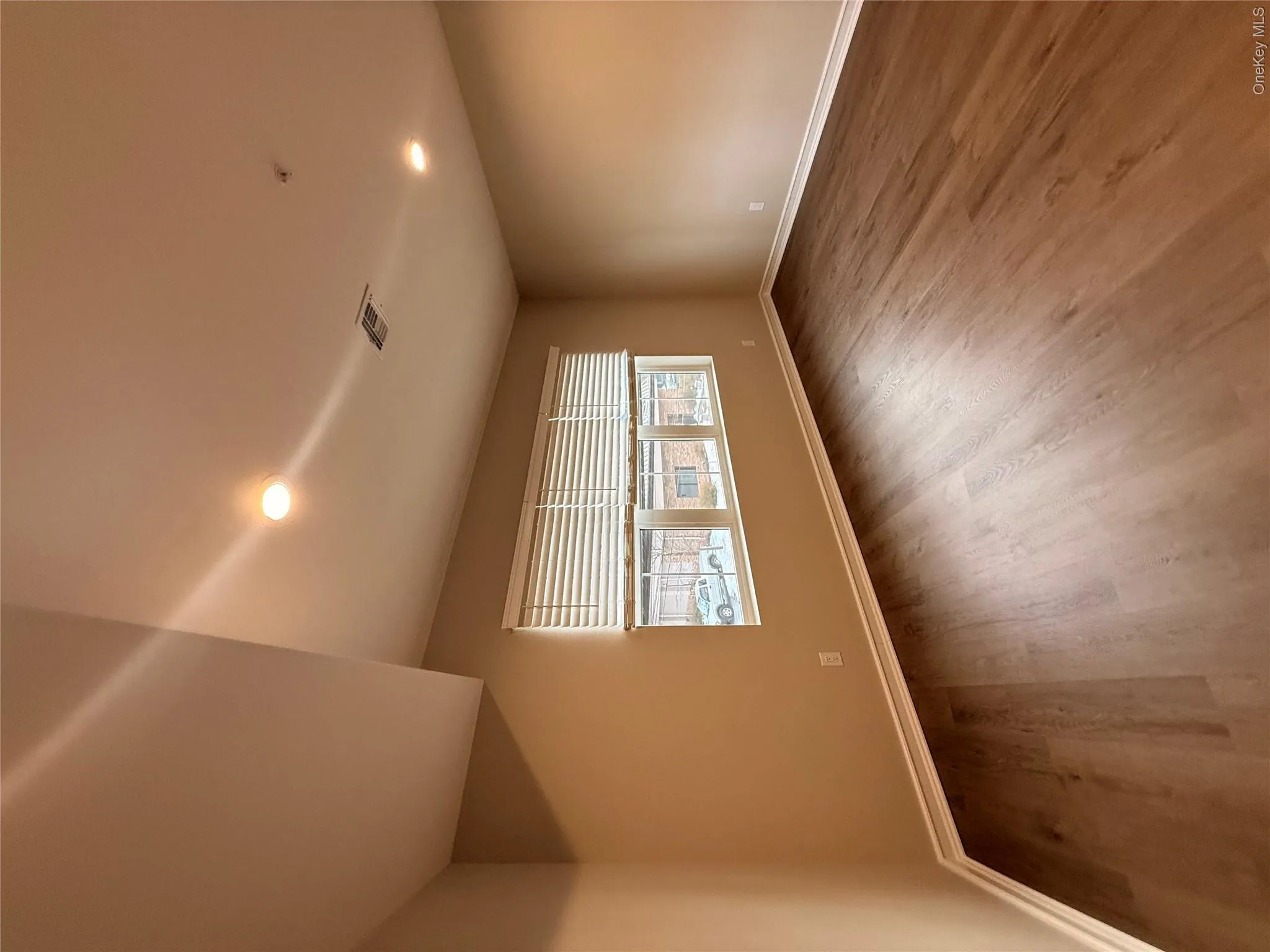 Spare room featuring recessed lighting and dark wood-type flooring Spare room featuring recessed lighting and dark wood-type flooring