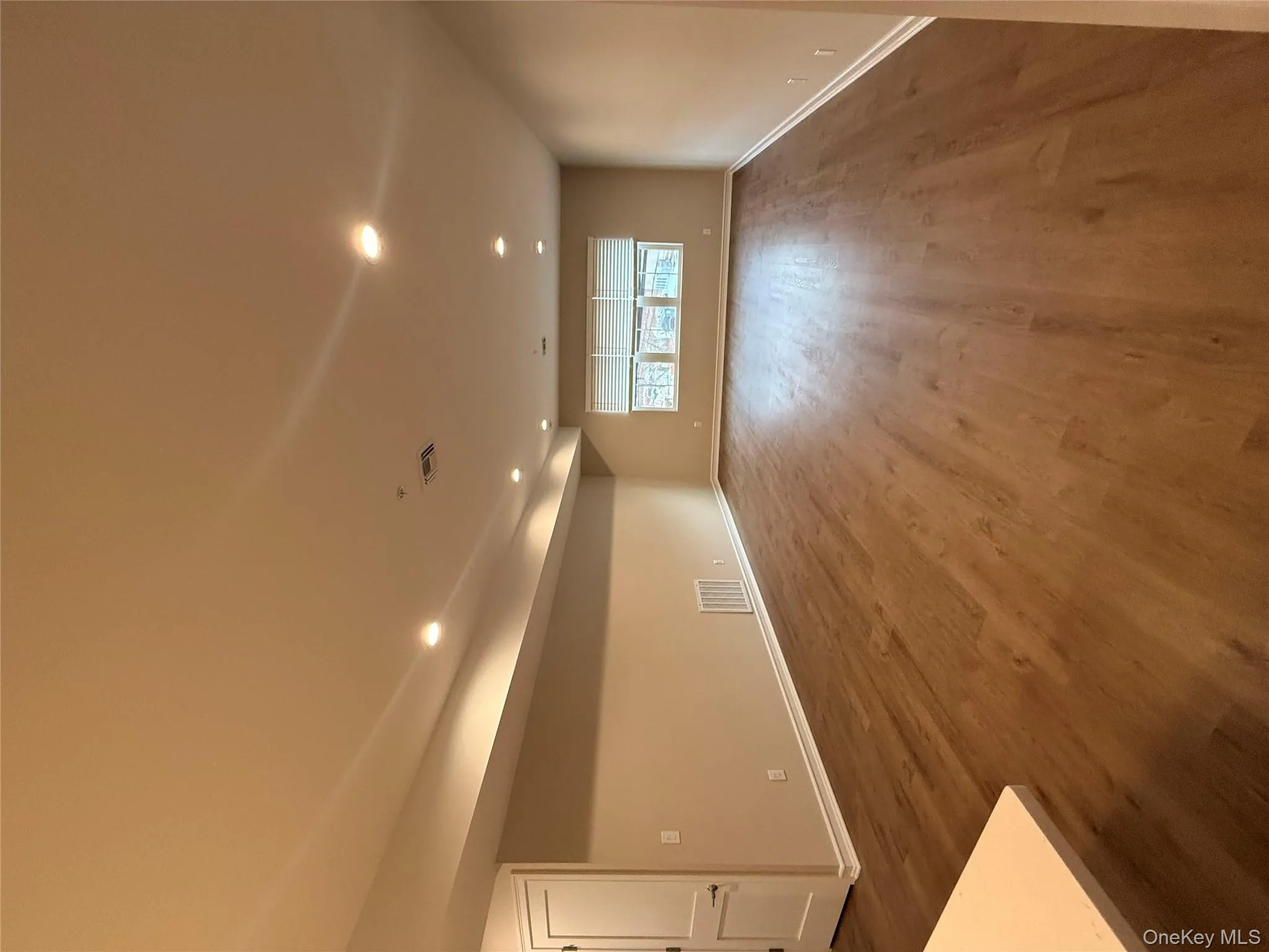 Spare room featuring recessed lighting and dark wood-style flooring Spare room featuring recessed lighting and dark wood-style flooring