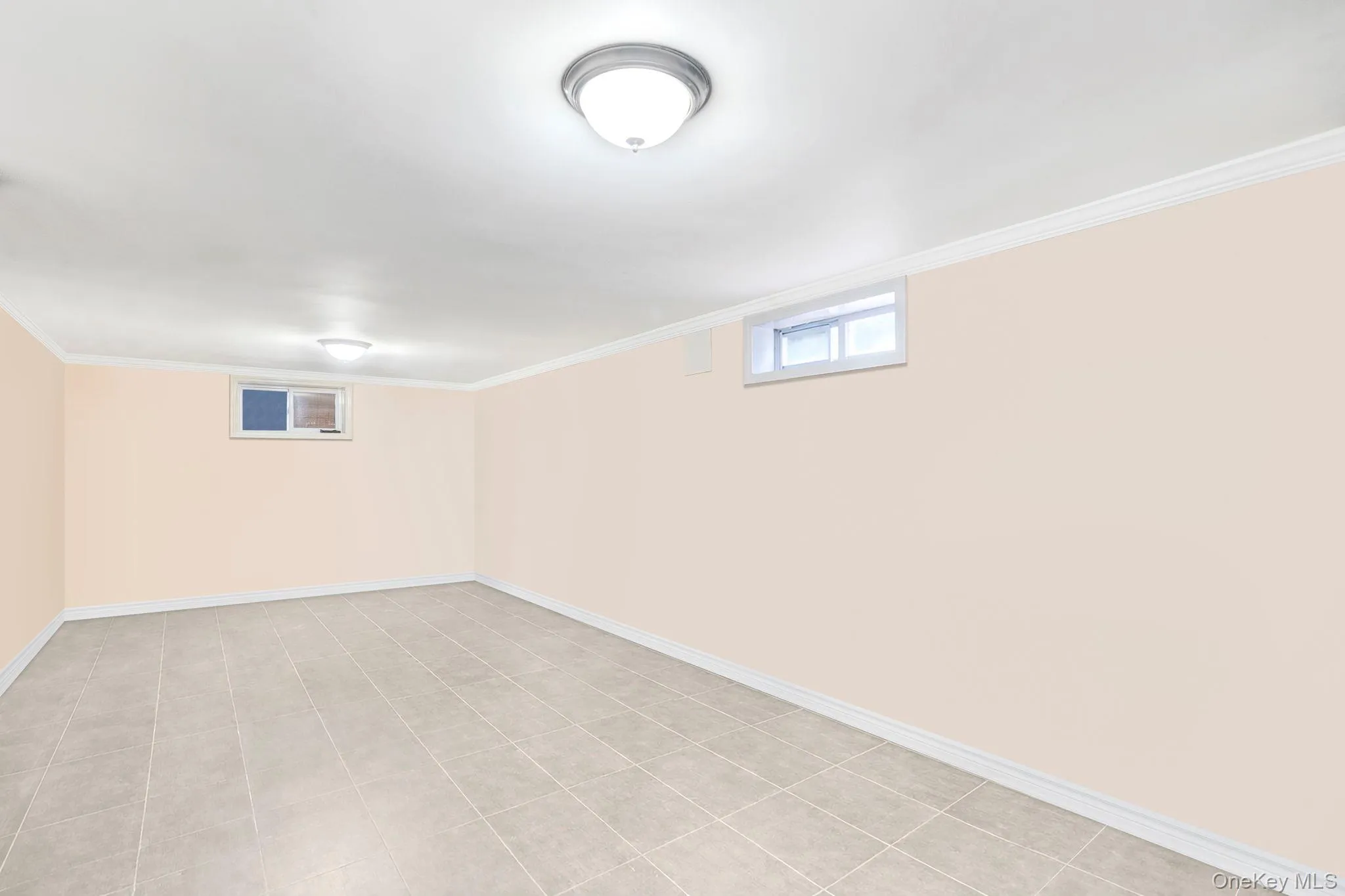 Basement featuring baseboards and ornamental molding Basement featuring baseboards and ornamental molding