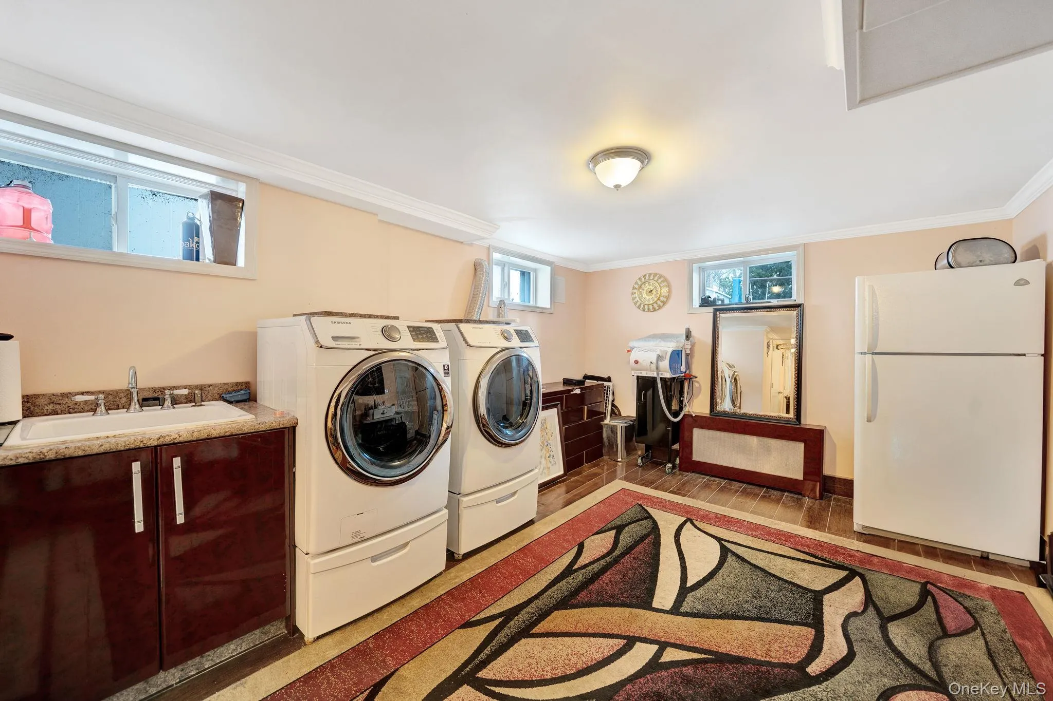 Laundry area with washer and dryer and light wood-style flooring Laundry area with washer and dryer and light wood-style flooring