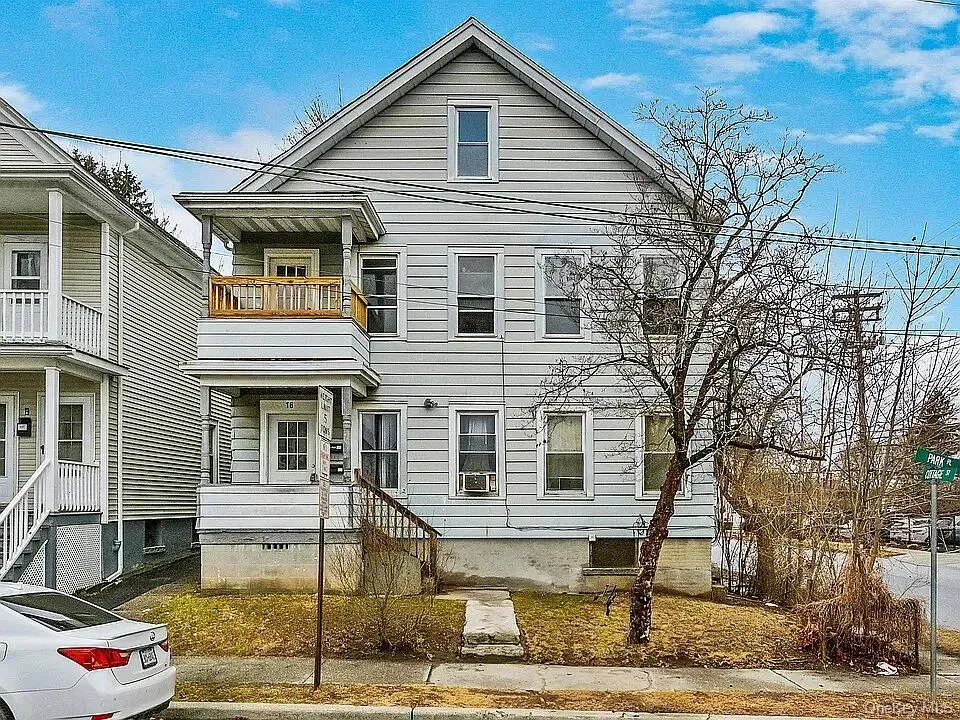 View of front of property featuring a balcony View of front of property featuring a balcony