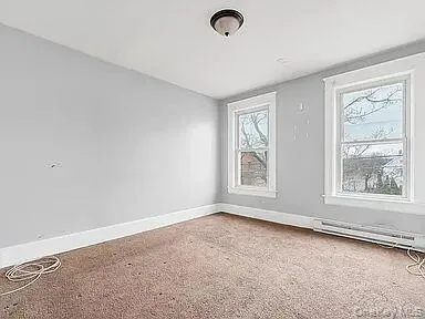 Spare room featuring baseboards and baseboard heating Spare room featuring baseboards and baseboard heating