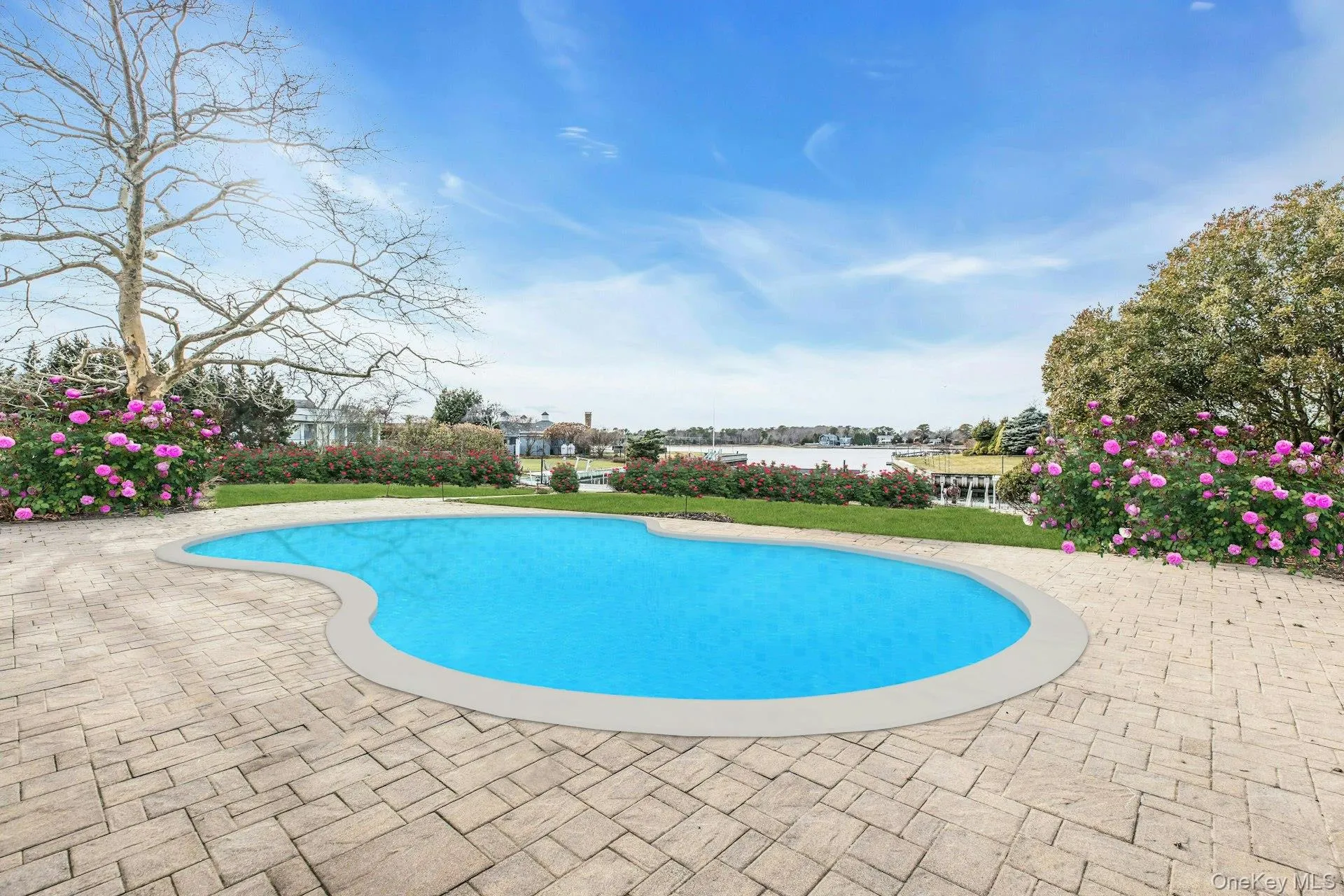 Swimming pool with a water view and a patio area
