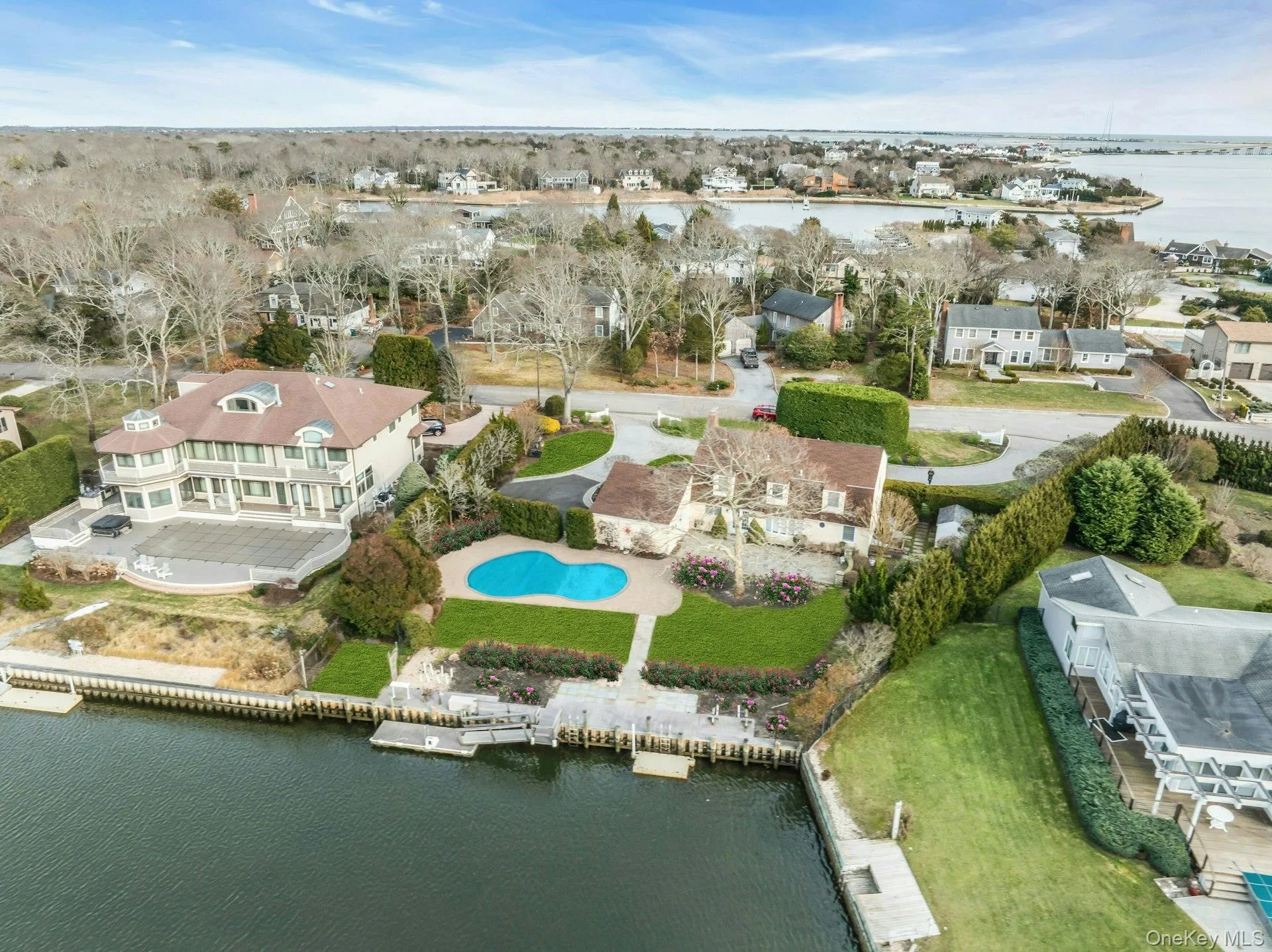 Aerial view of property's location featuring a large body of water and nearby suburban area