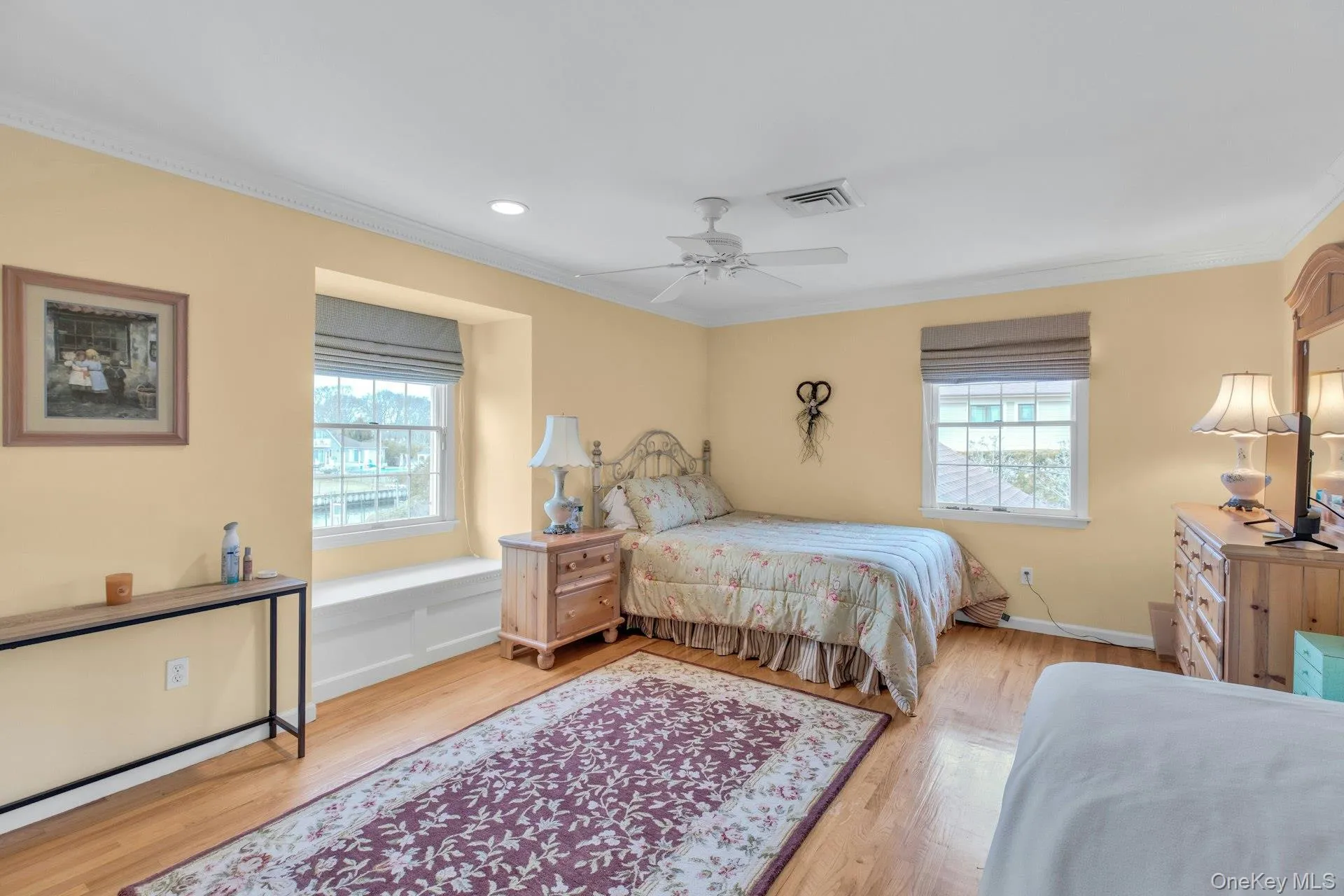 Bedroom featuring ceiling fan, light wood-type flooring, ornamental molding, and recessed lighting