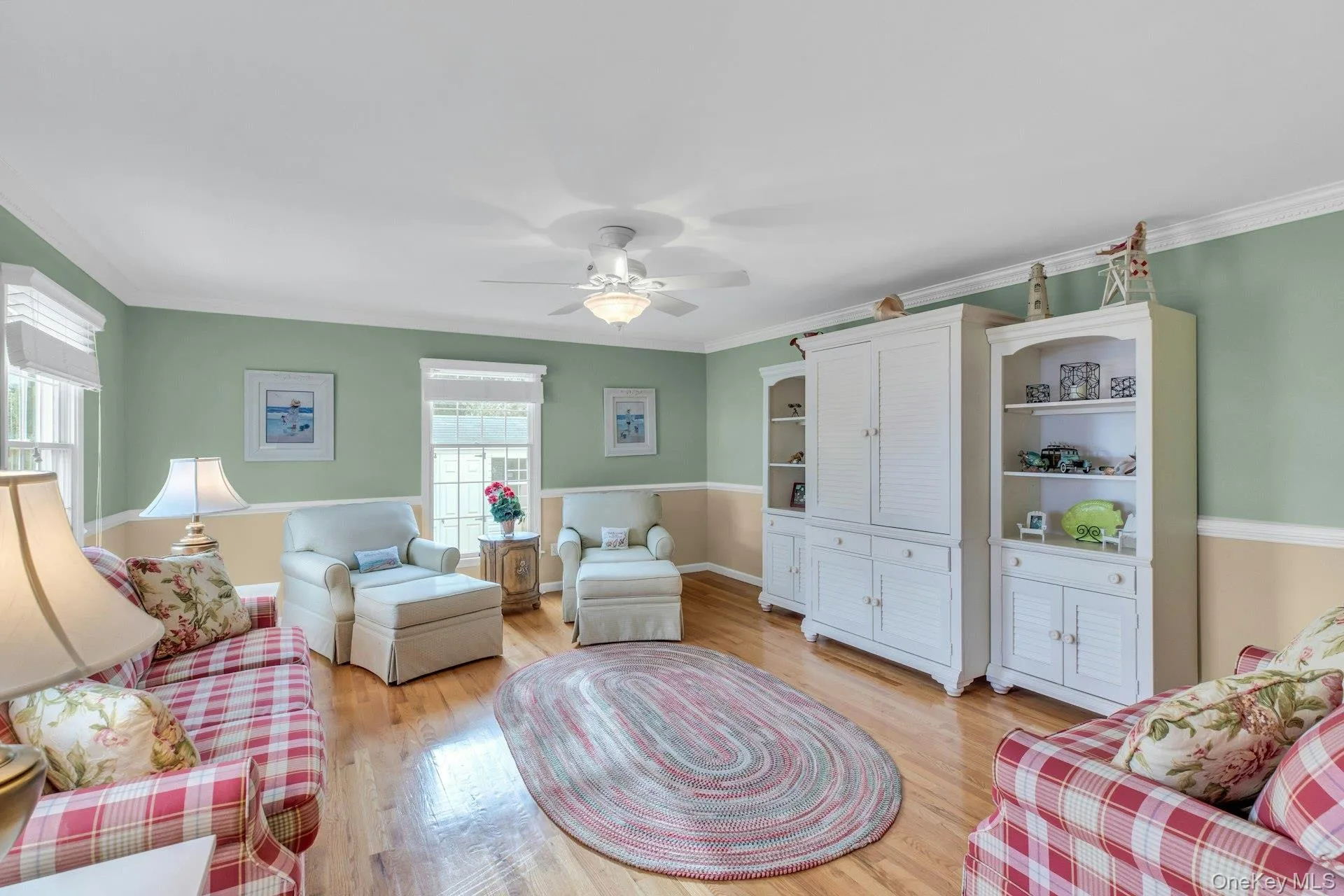 Living area with crown molding, light wood finished floors, and ceiling fan