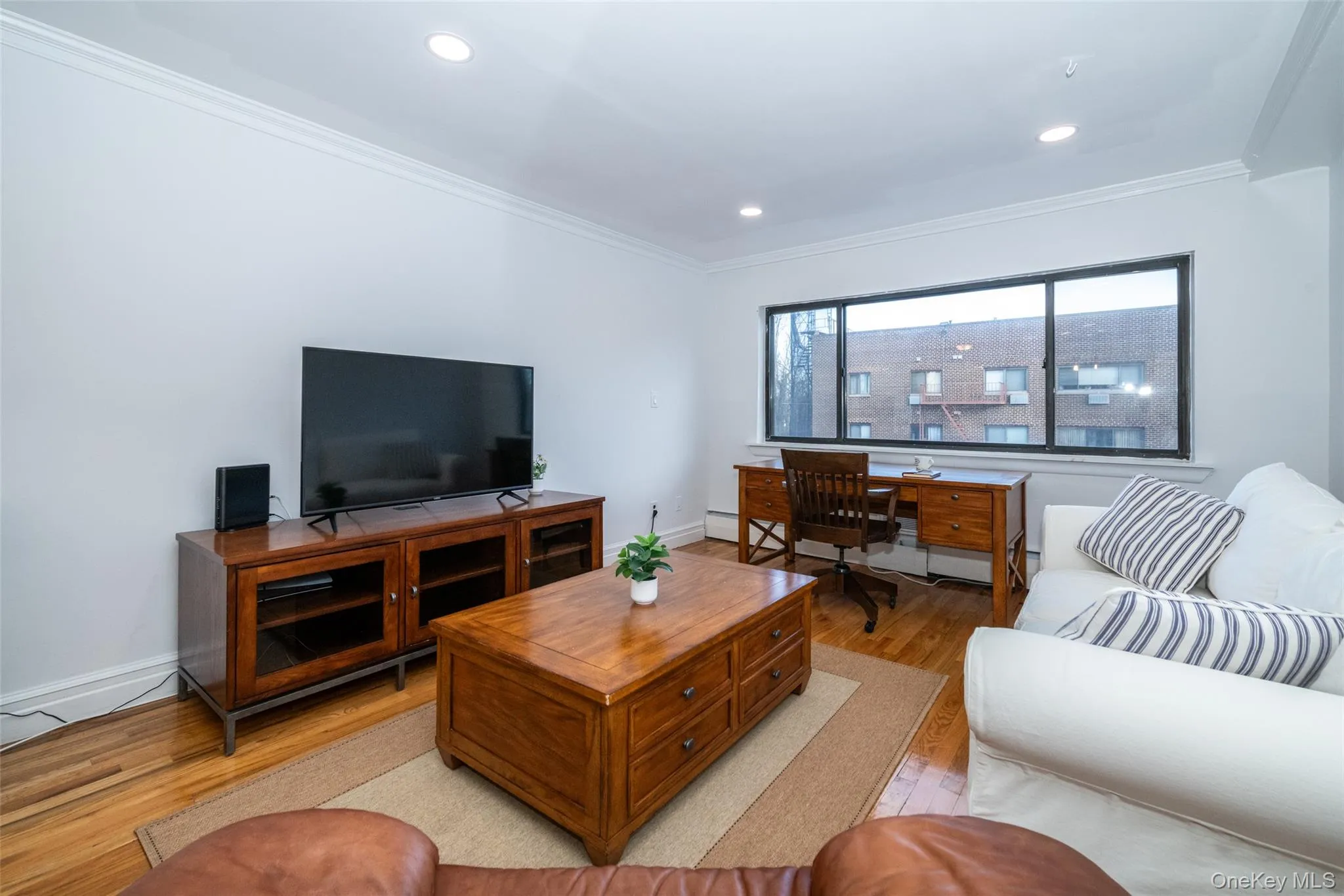 Living room featuring light wood-type flooring, an office area, ornamental molding, and recessed lighting Living room featuring light wood-type flooring, an office area, ornamental molding, and recessed lighting